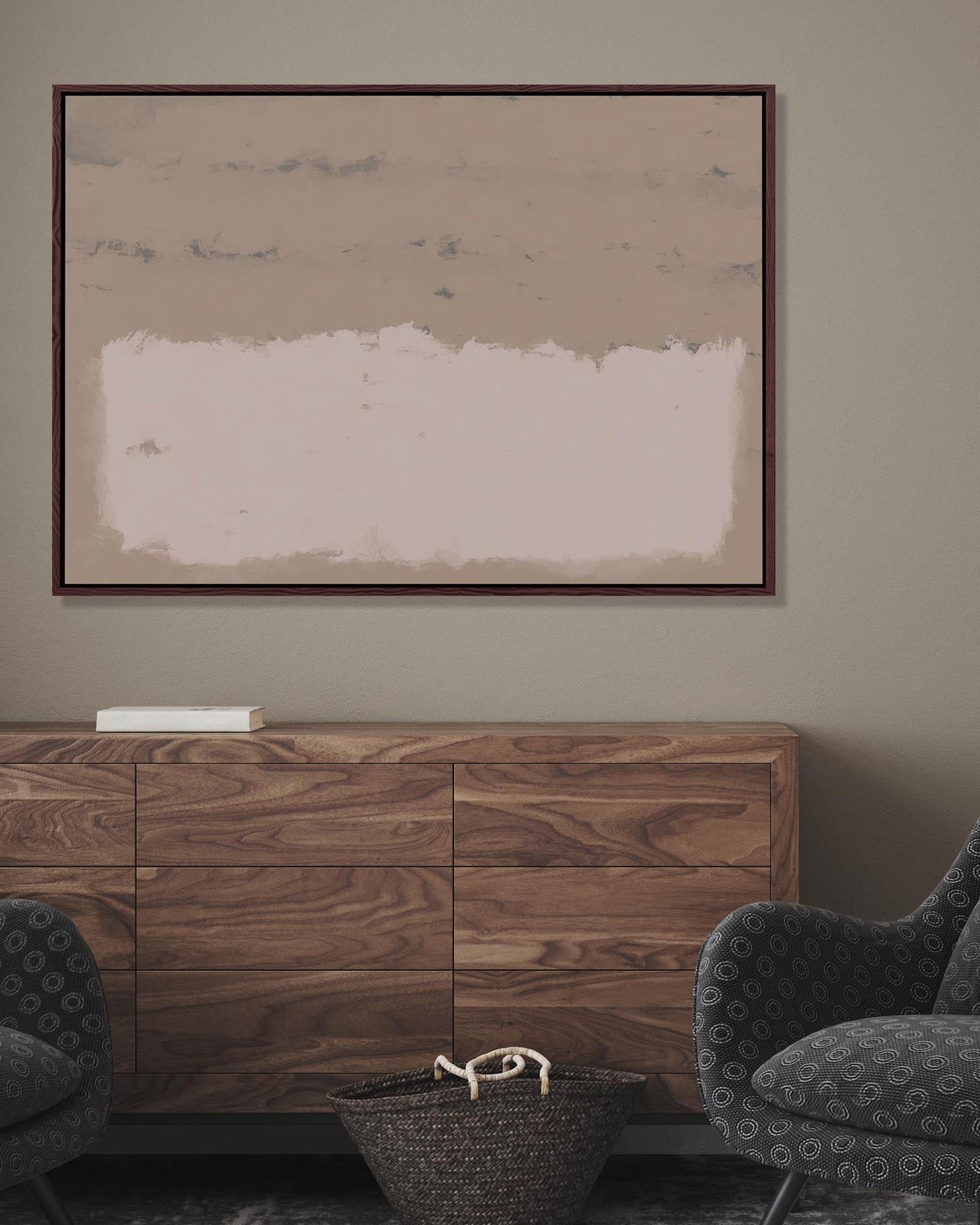 Wooden sideboard with abstract painting on wall in a room with dark gray chairs.