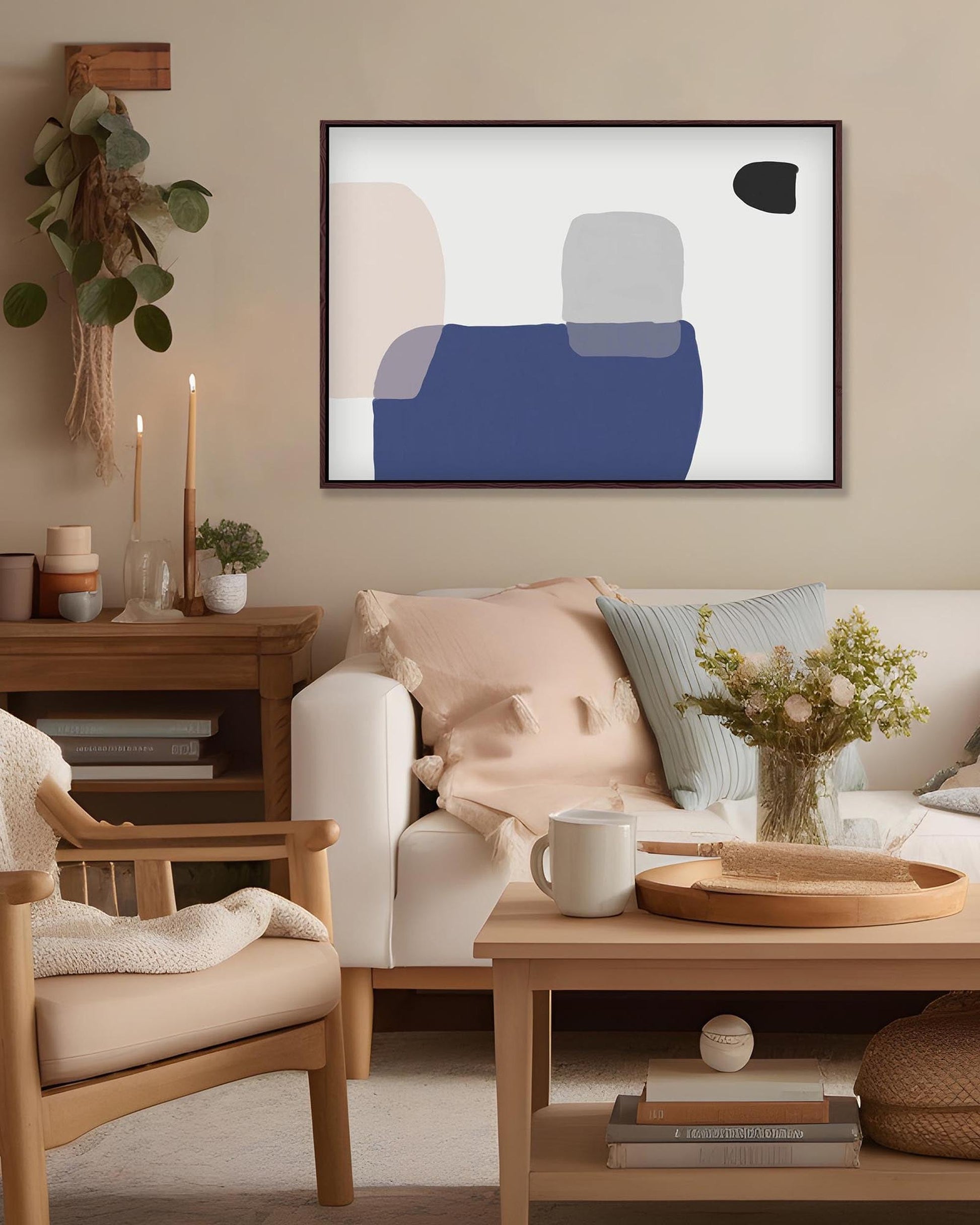 Cozy living room with a beige armchair, white sofa, and abstract art on the wall.