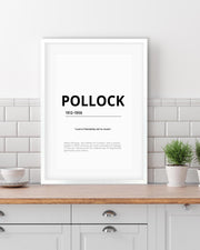 Framed poster with 'POLLOCK' and text on a kitchen counter.