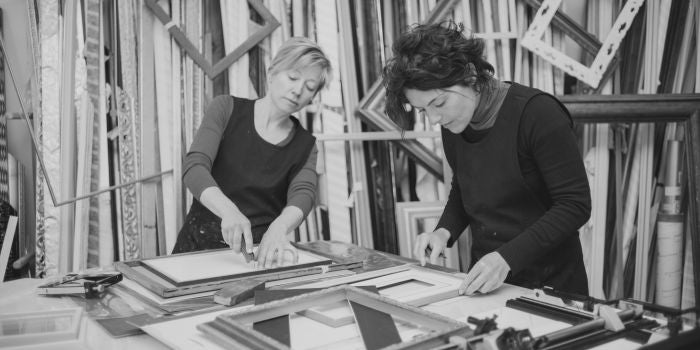 picture framing shop with two woman making frames by hand