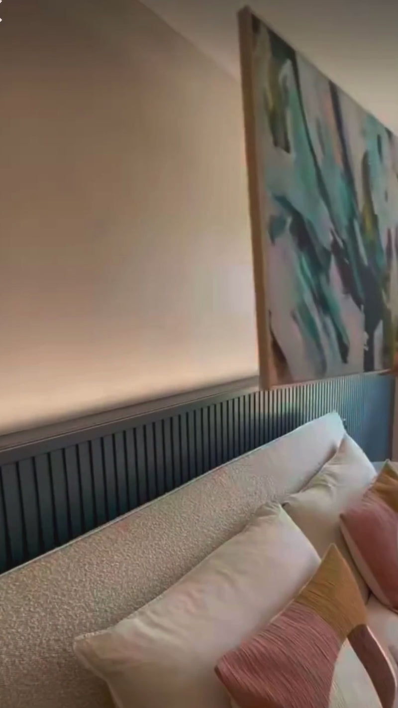 Modern blue and teal large abstract canvas art in modern colourful bedroom interior.