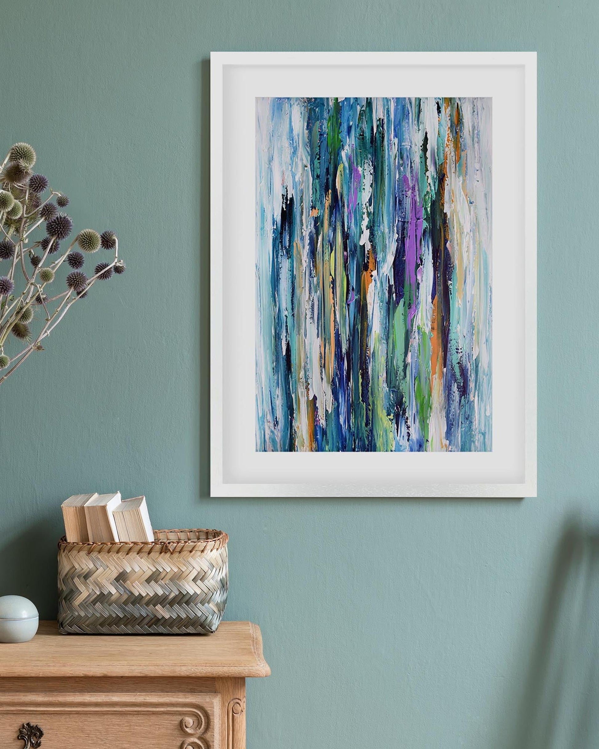 Framed abstract art on a wall with decorative items below