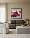 Modern living room with a brown sofa, white armchair, and abstract art on the wall.