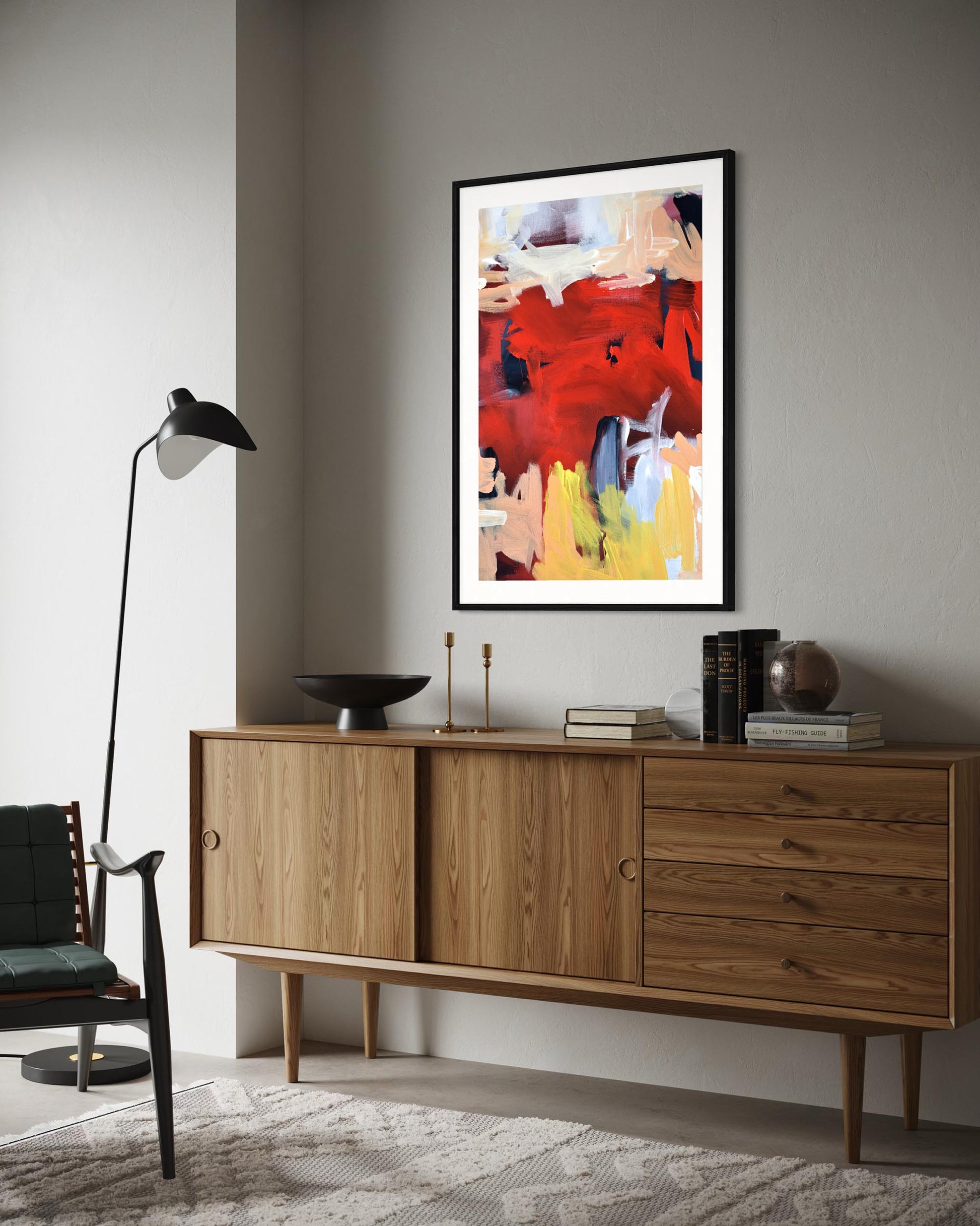 Wooden sideboard with a modern abstract painting above it in a room.