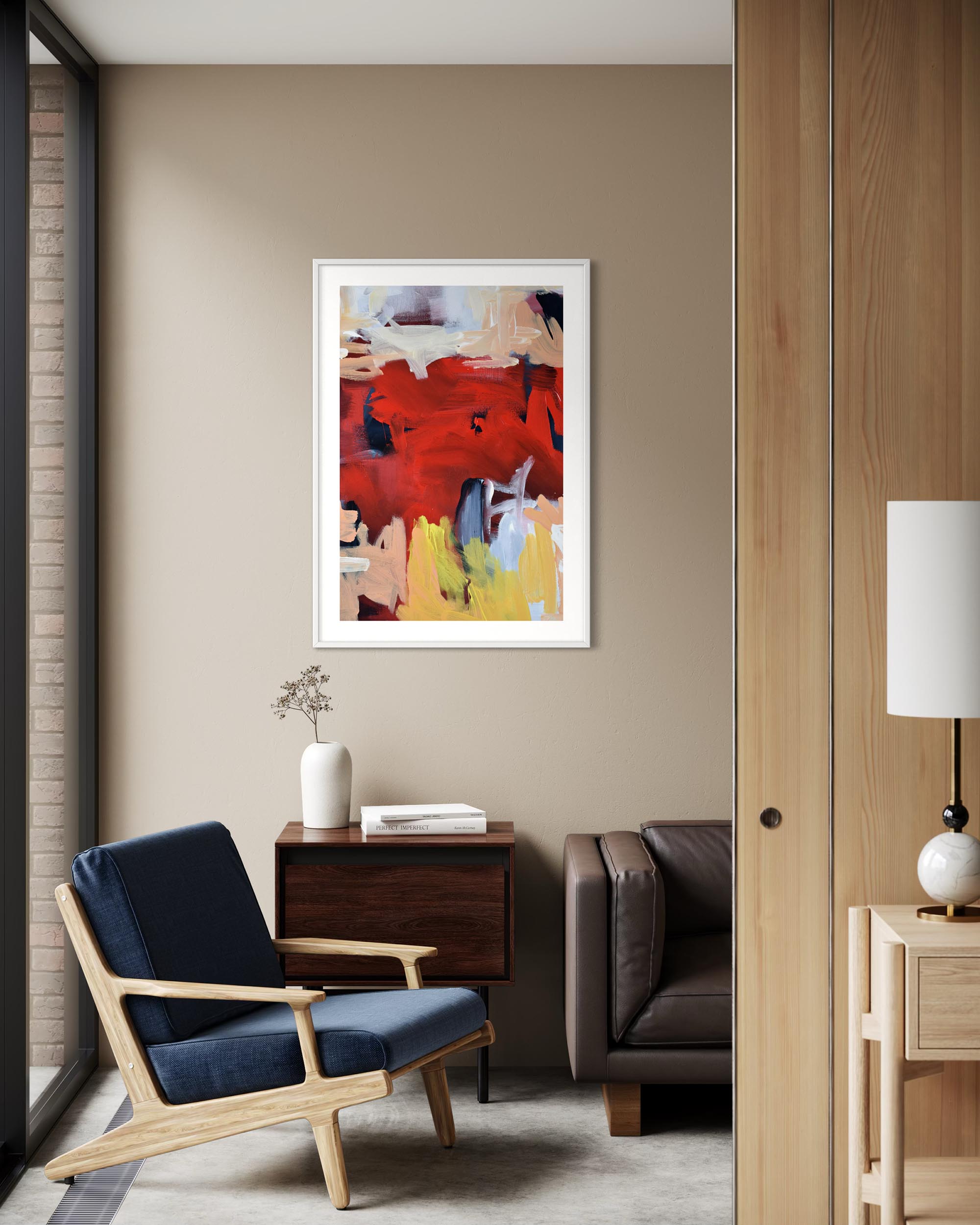 Modern living room with a blue armchair, abstract painting, and wooden side table.