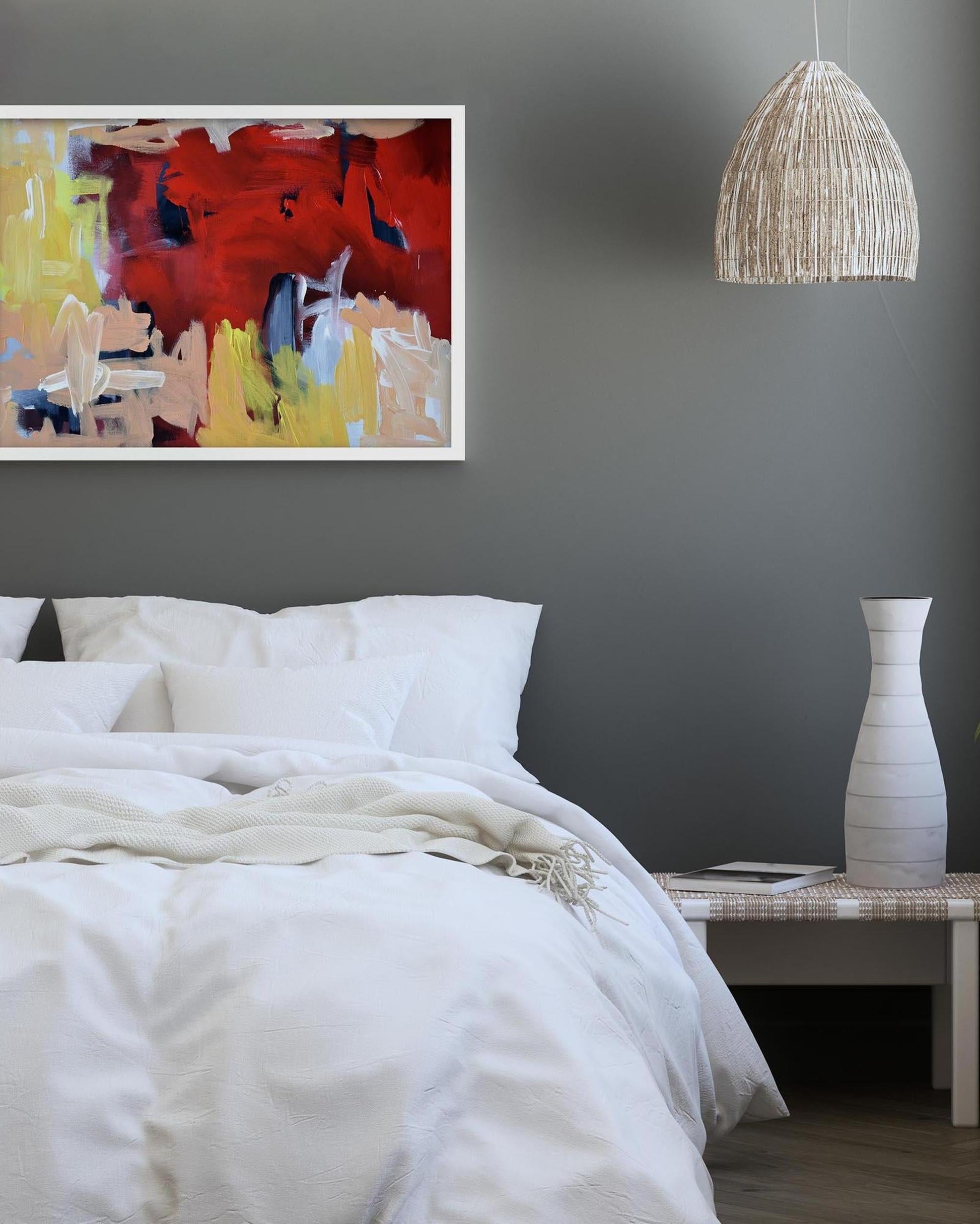 Bedroom with abstract painting, white bedding, and a vase on a nightstand.