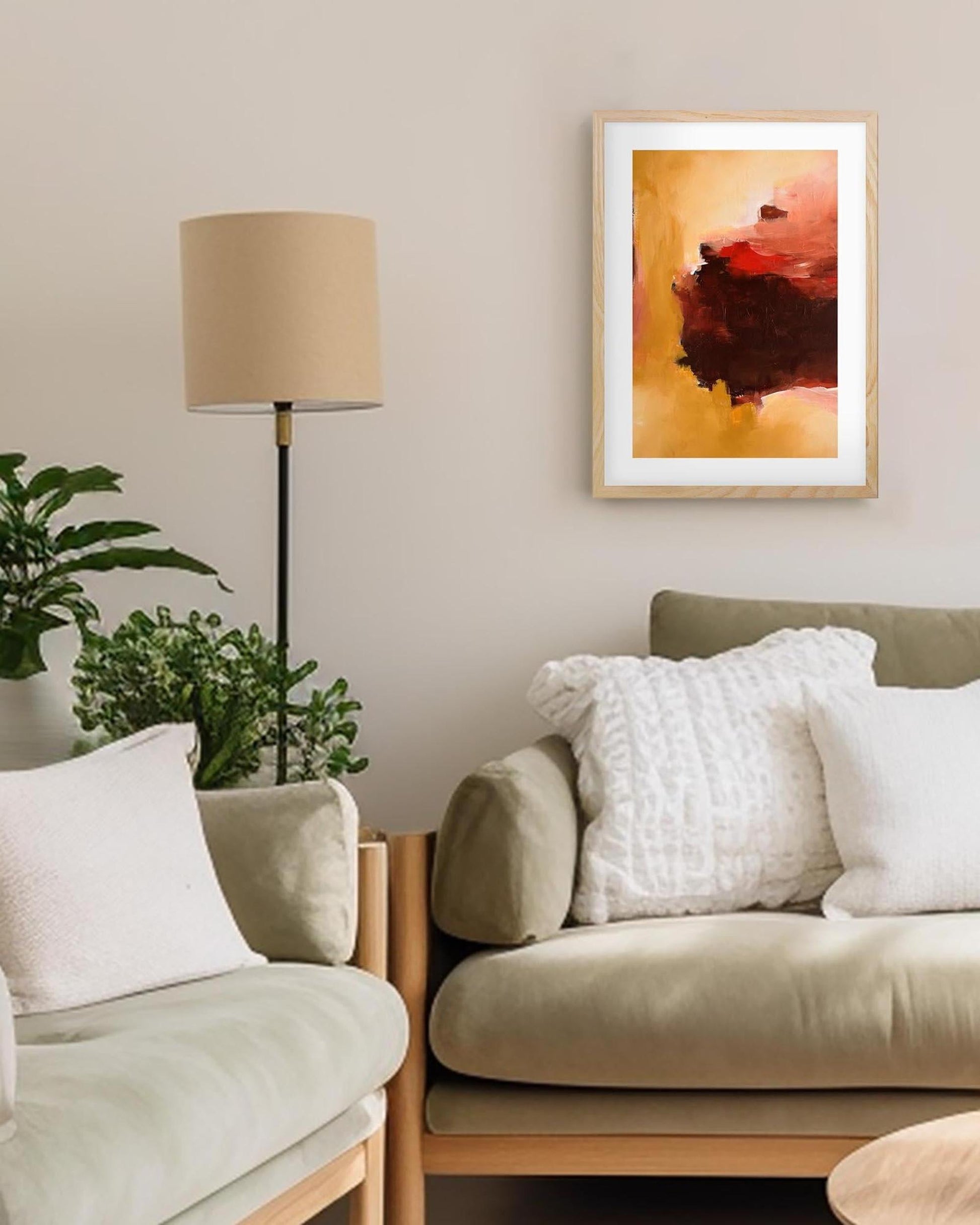 Living room with beige sofa, lamp, and framed abstract art on wall