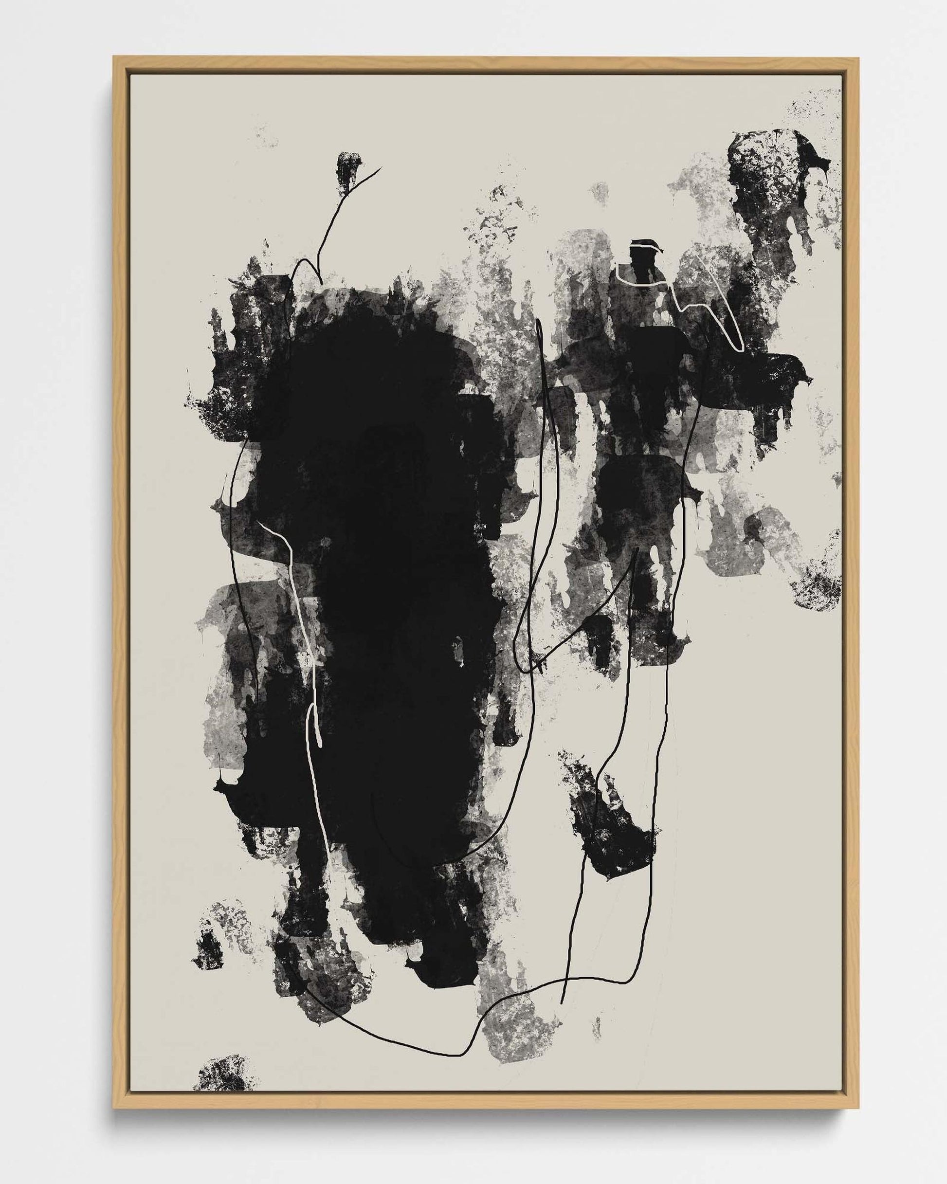 Abstract black and white artwork in a wooden frame on a beige background