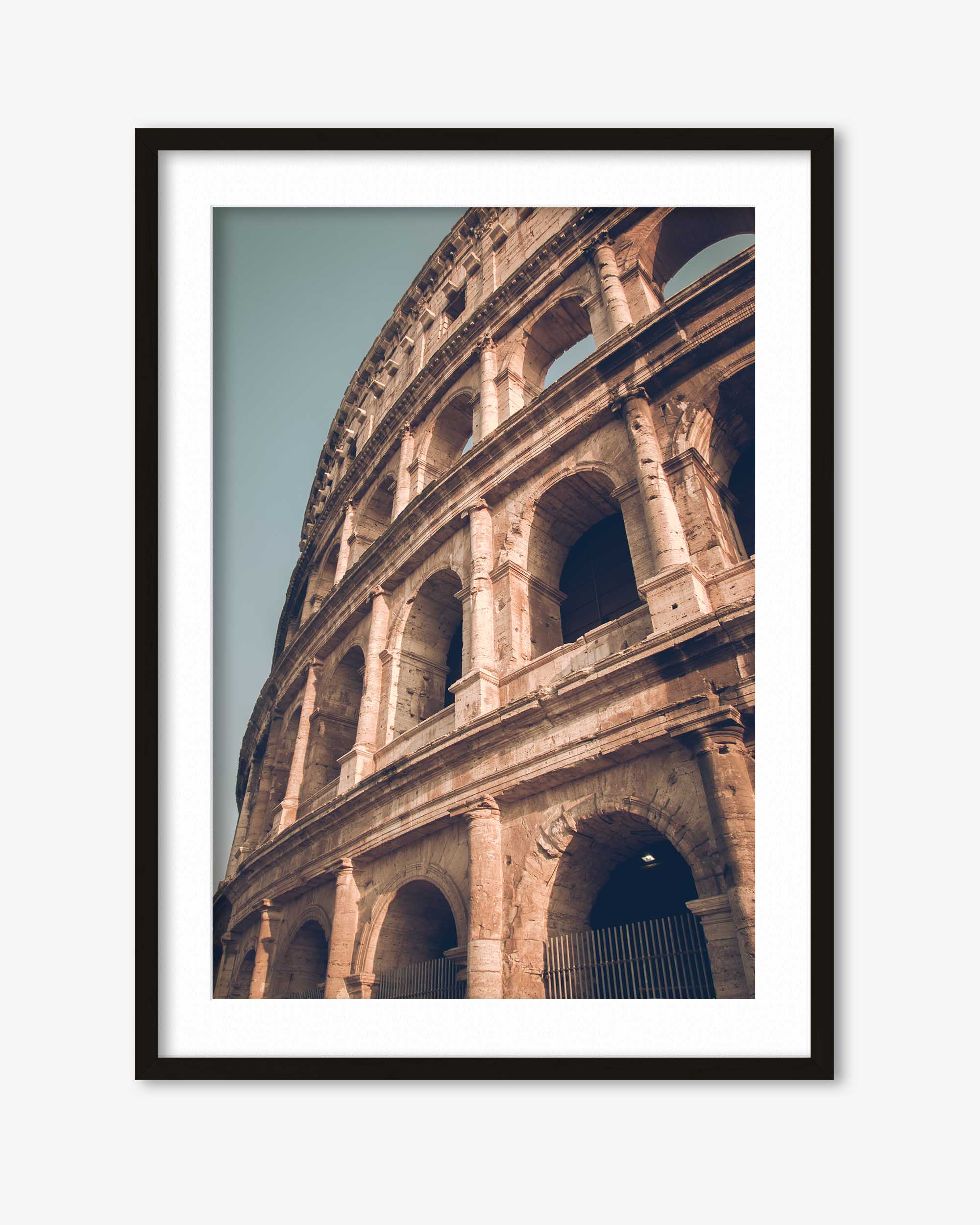 Framed photograph of the Colosseum in Rome against a light blue sky.