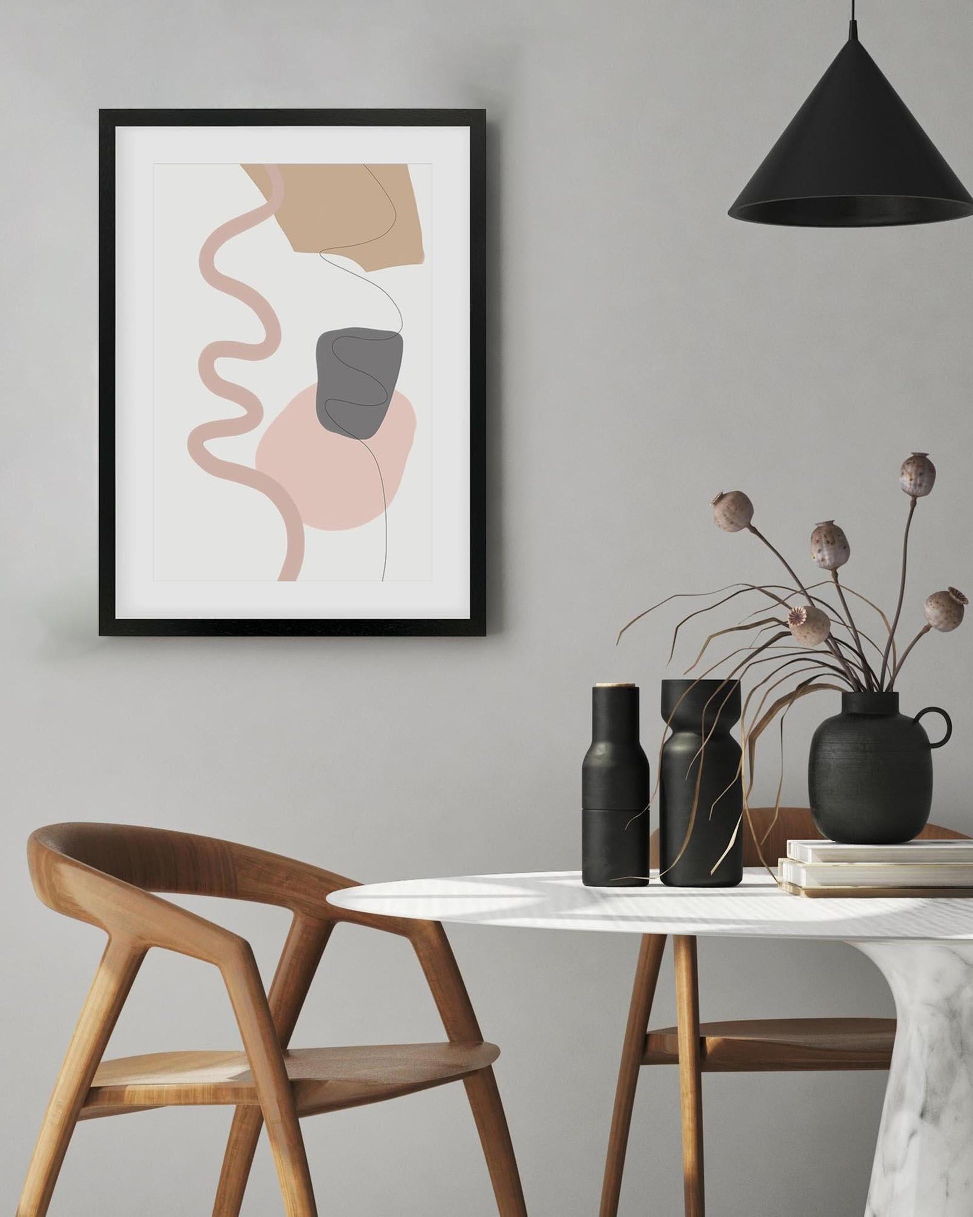 Modern interior with abstract art, wooden chair, and decorative items on a table.