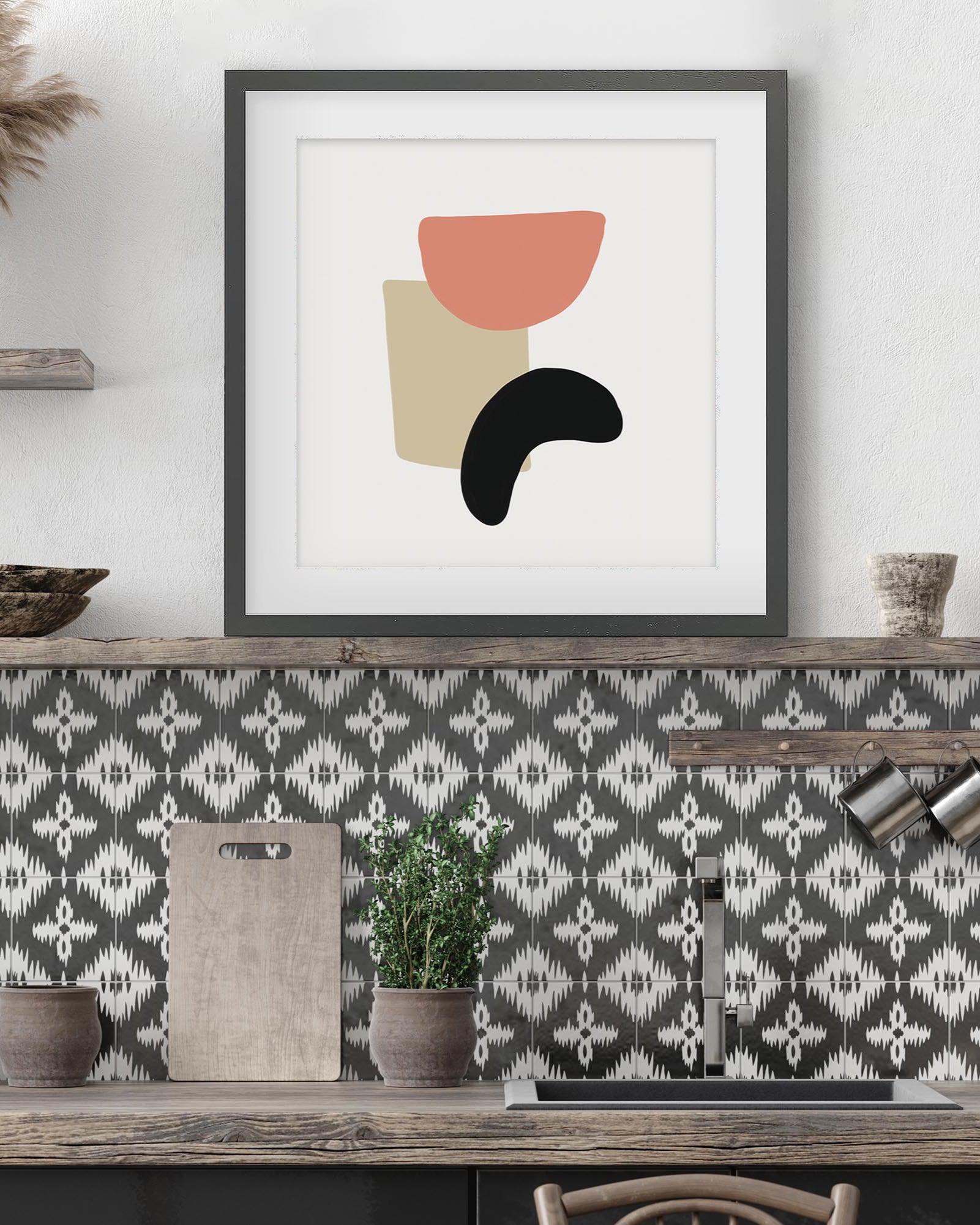 Framed abstract art print on a wall above a patterned wallpapered wall.