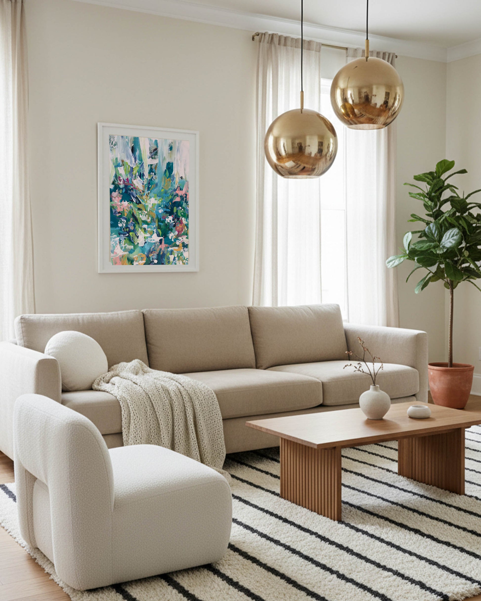large wall art framed with modern colourful palette, brass bubble light and 3 seater beige fabric sofa and large olive tree.
