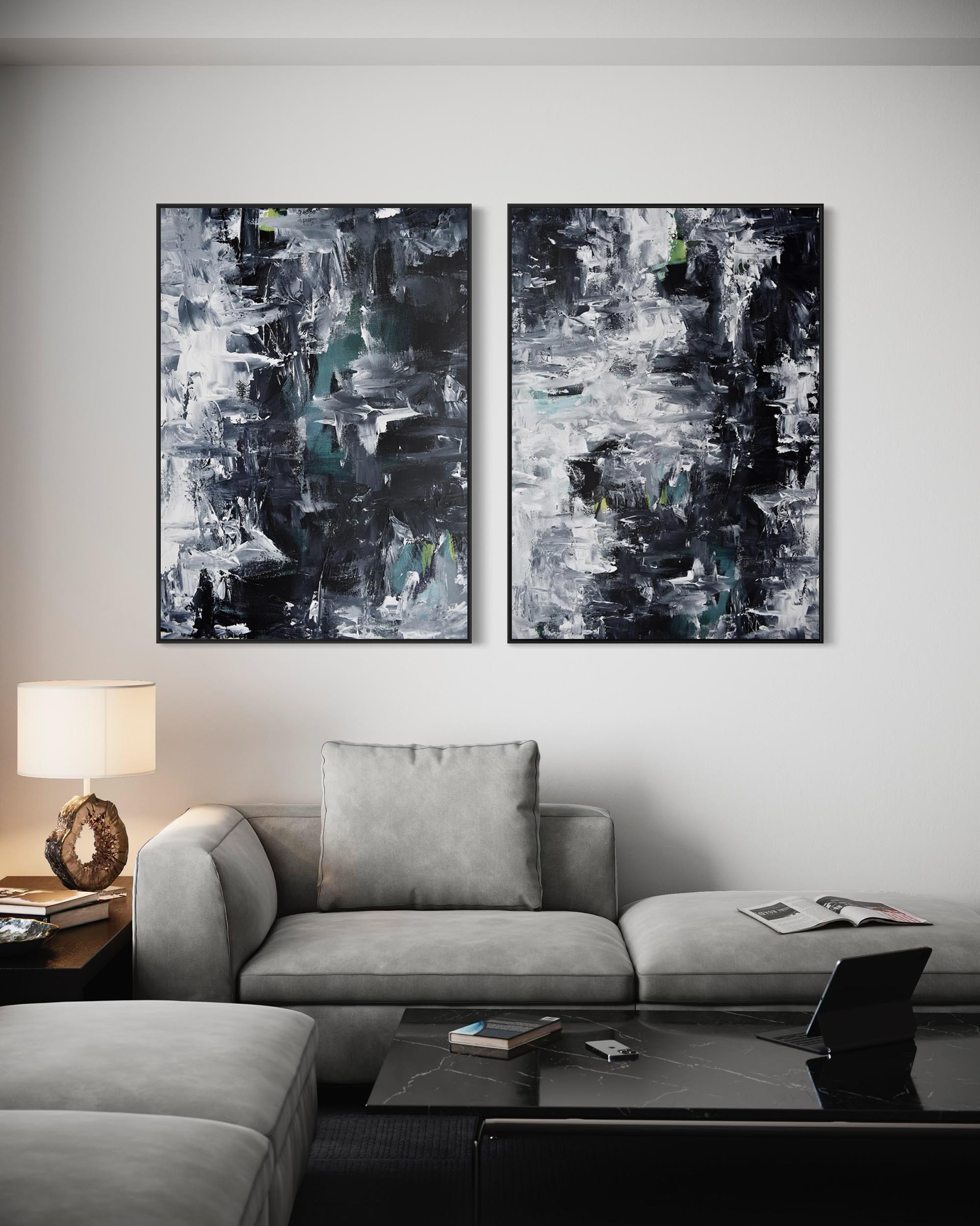 Two abstract paintings on a wall above a sofa in a living room.