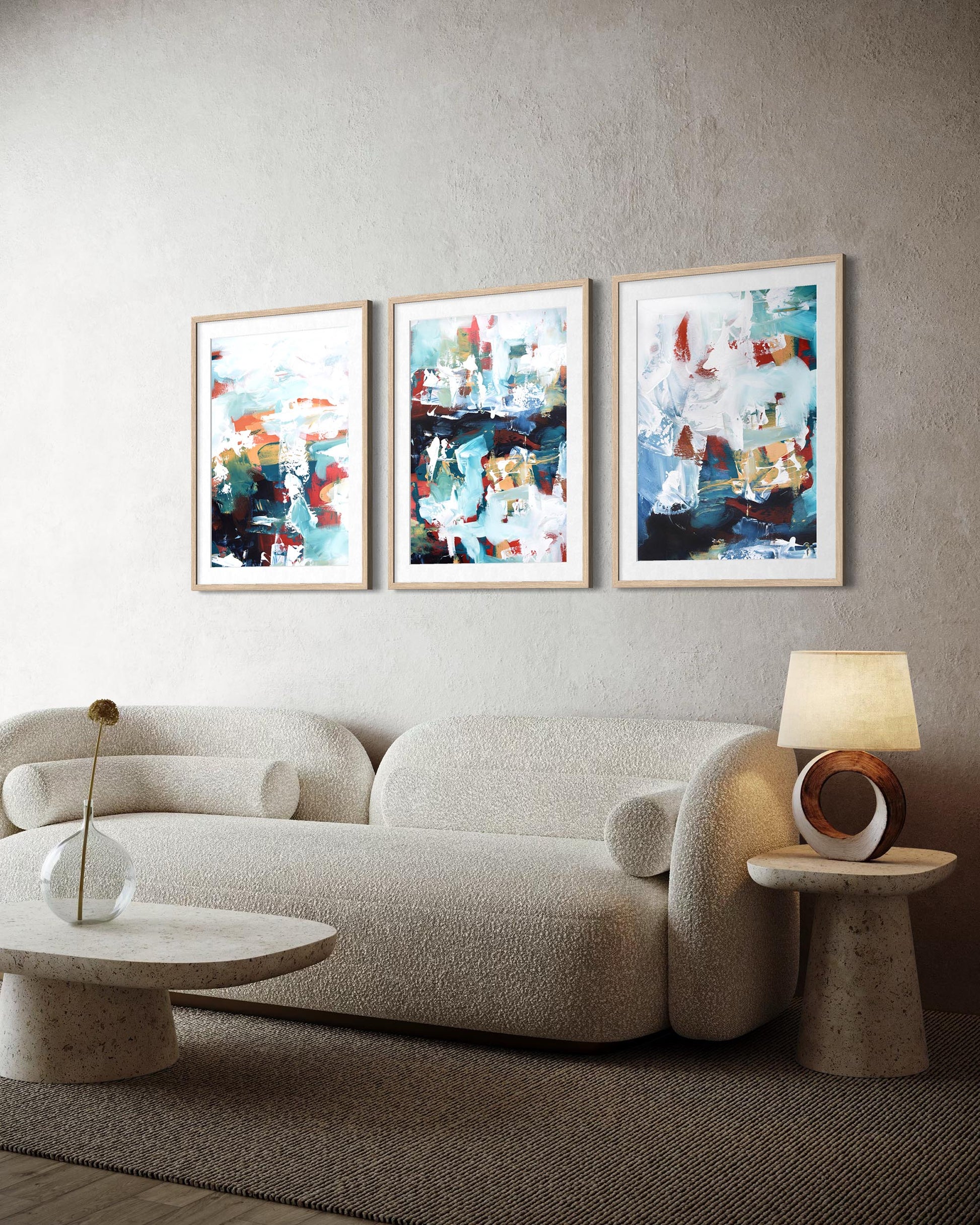 Modern living room with a beige sofa, abstract art on the wall, and side tables.