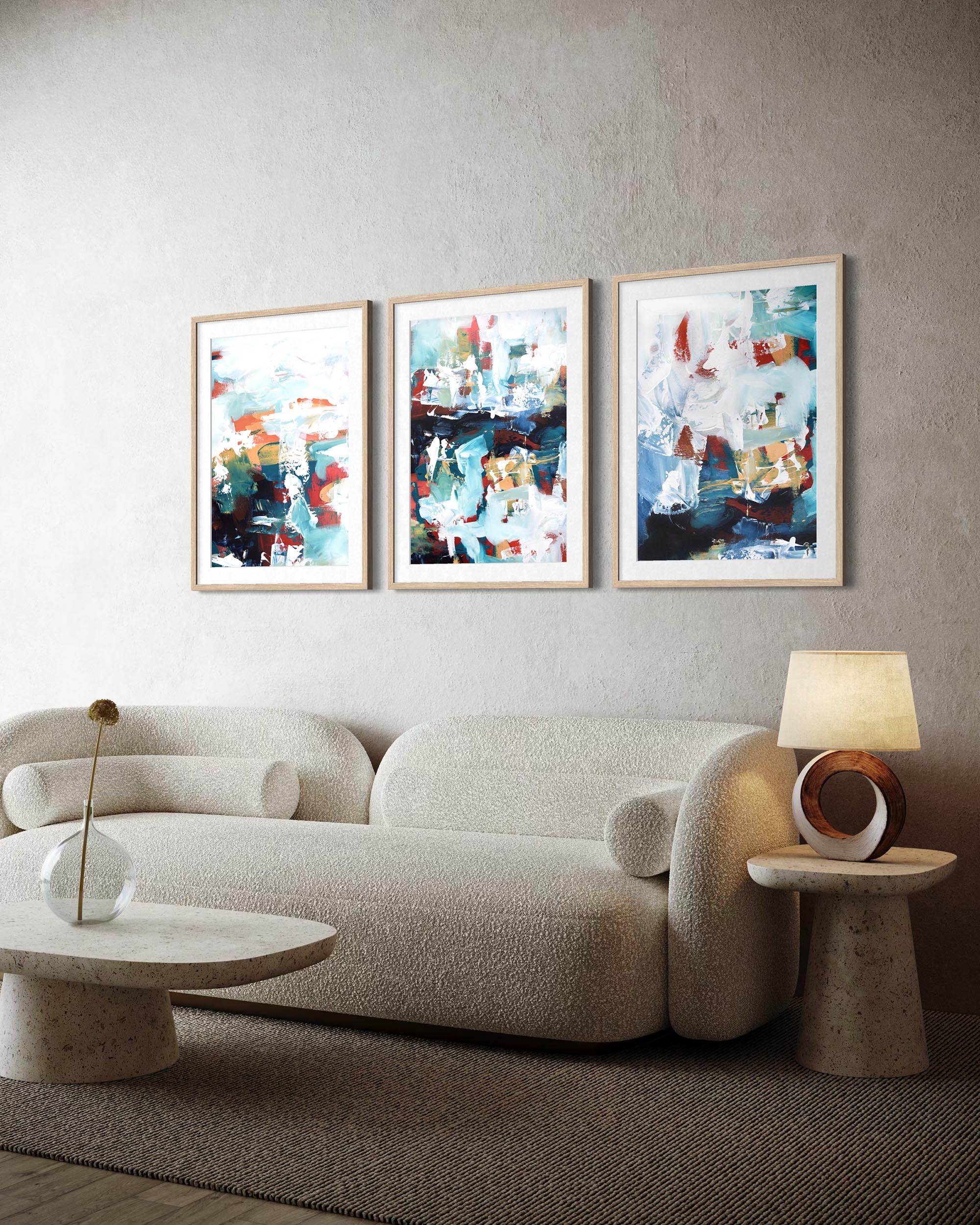 Modern living room with a beige sofa, abstract art on the wall, and side tables.