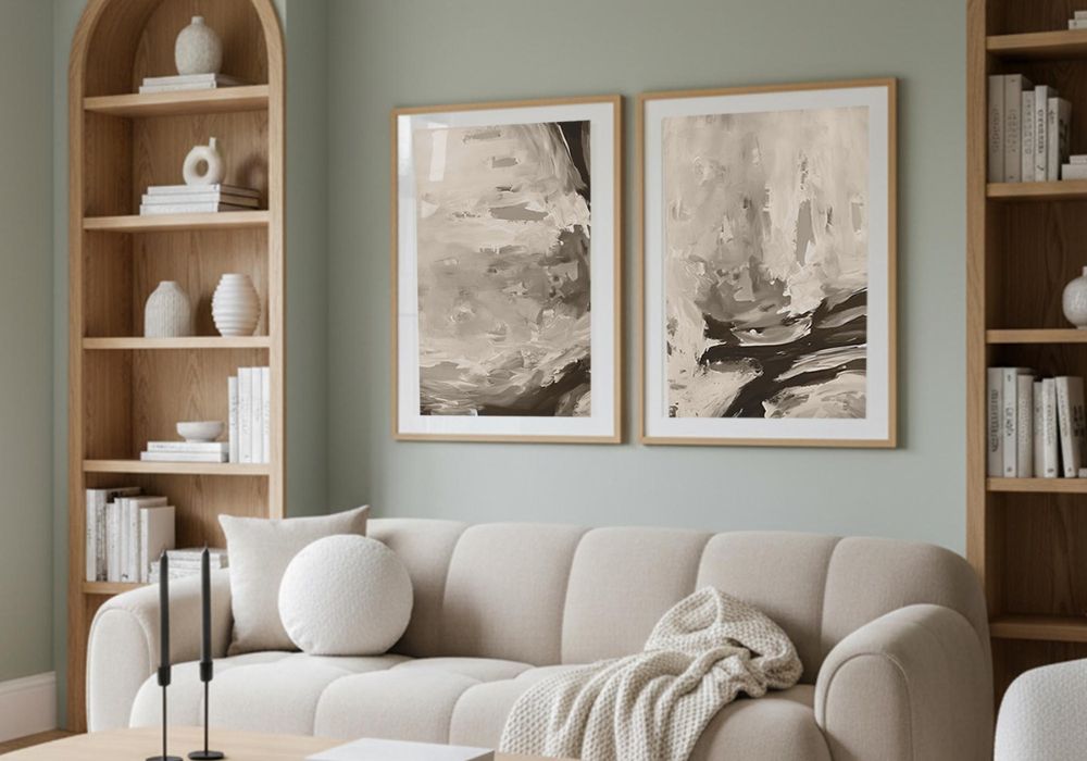 Living room with a beige sofa, abstract art on the wall, and wooden bookshelves.