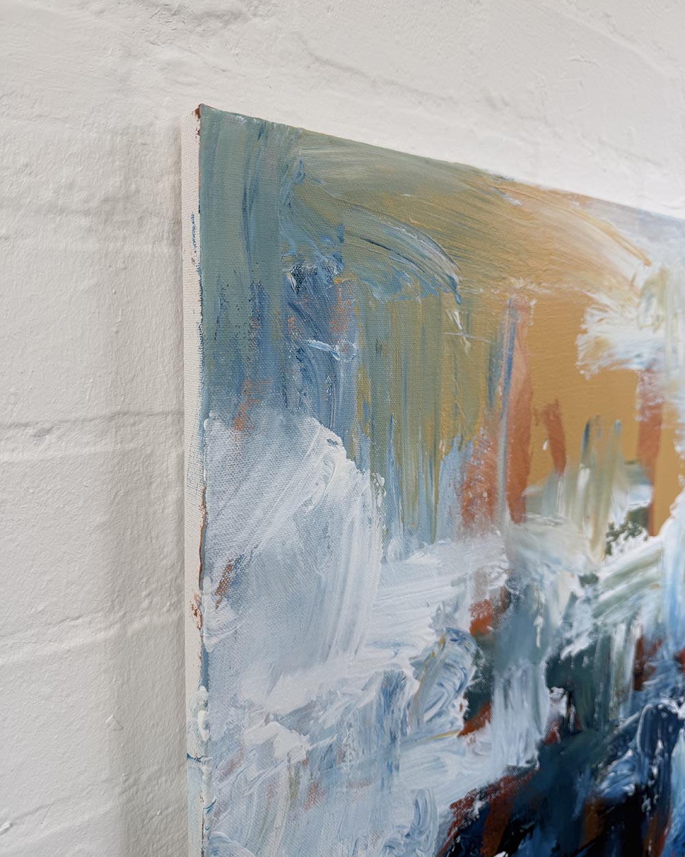 Abstract painting on a textured white wall