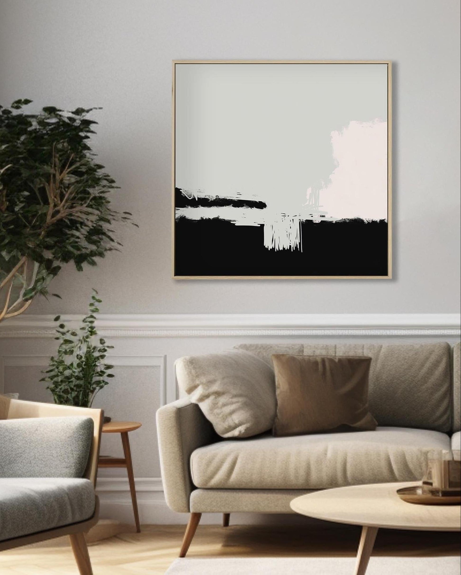 Living room with a sofa, armchair, and abstract art on the wall.