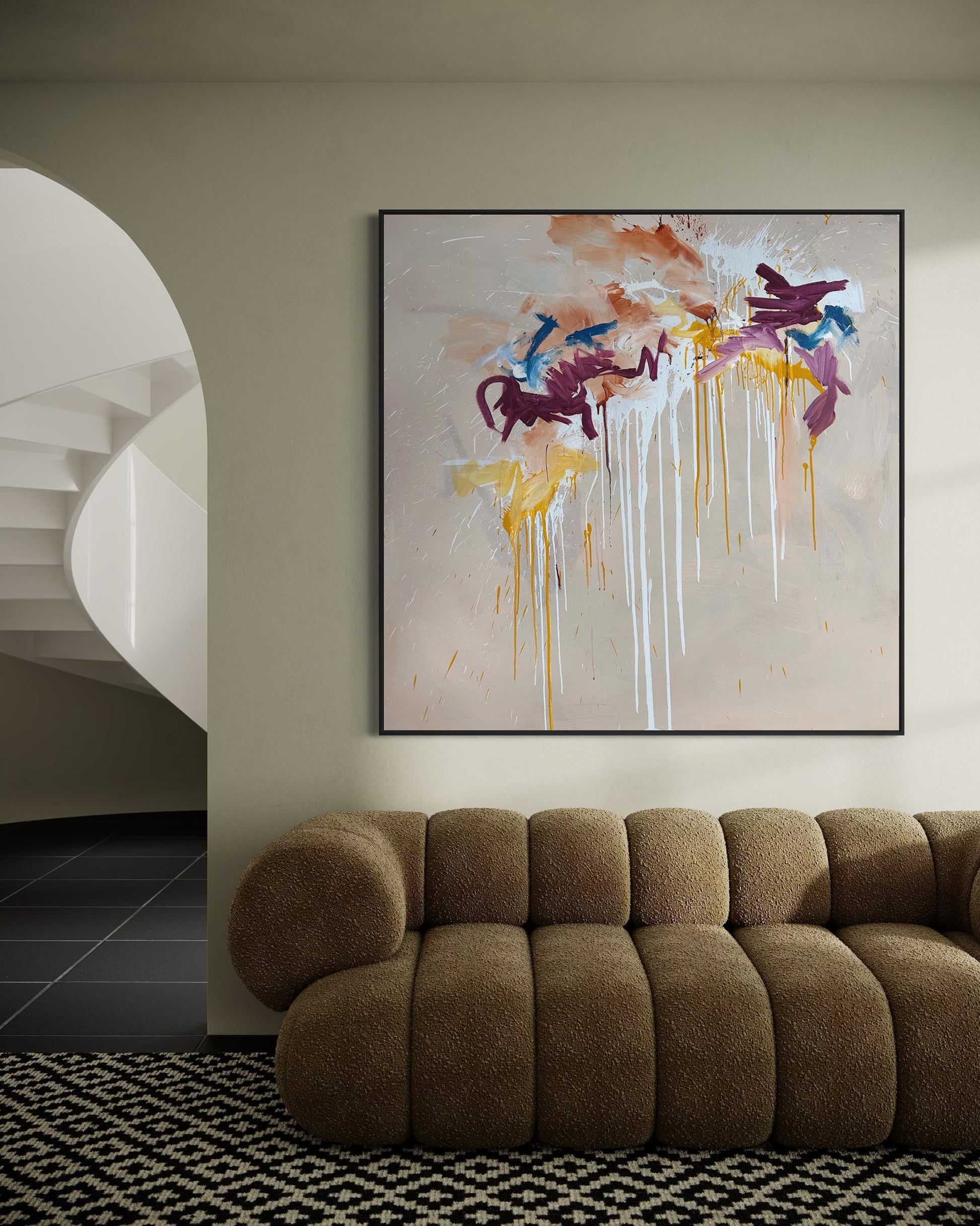 Modern living room with a brown sofa and abstract art on the wall.