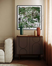 Modern living room with abstract art, sideboard, and decor items.