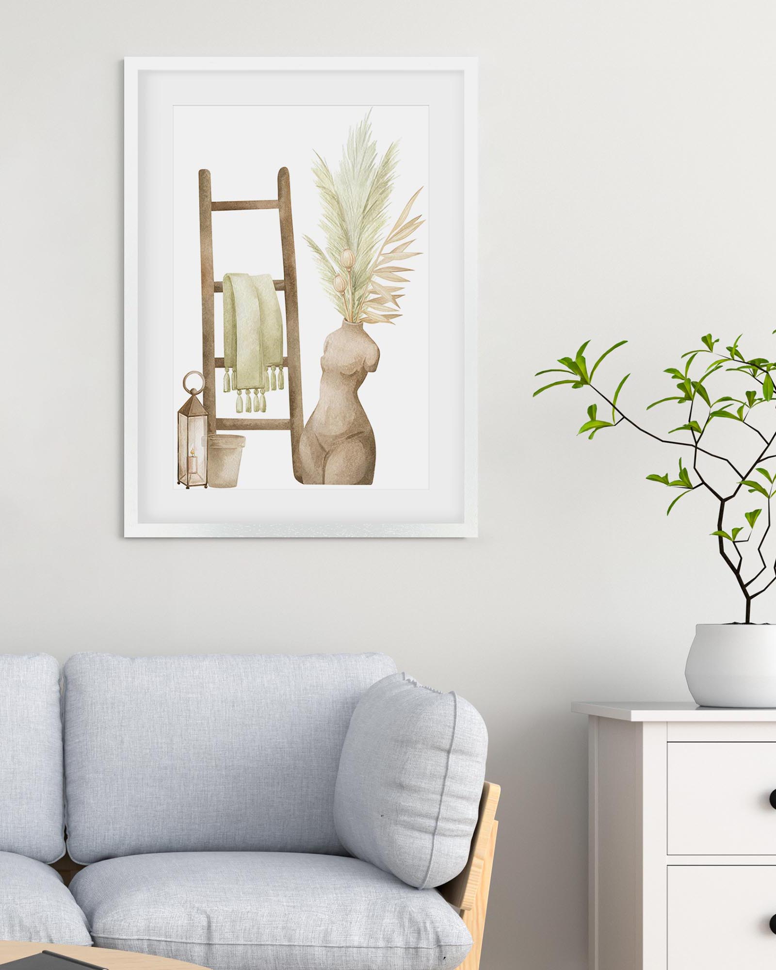 Framed artwork with decorative elements on a wall above a sofa