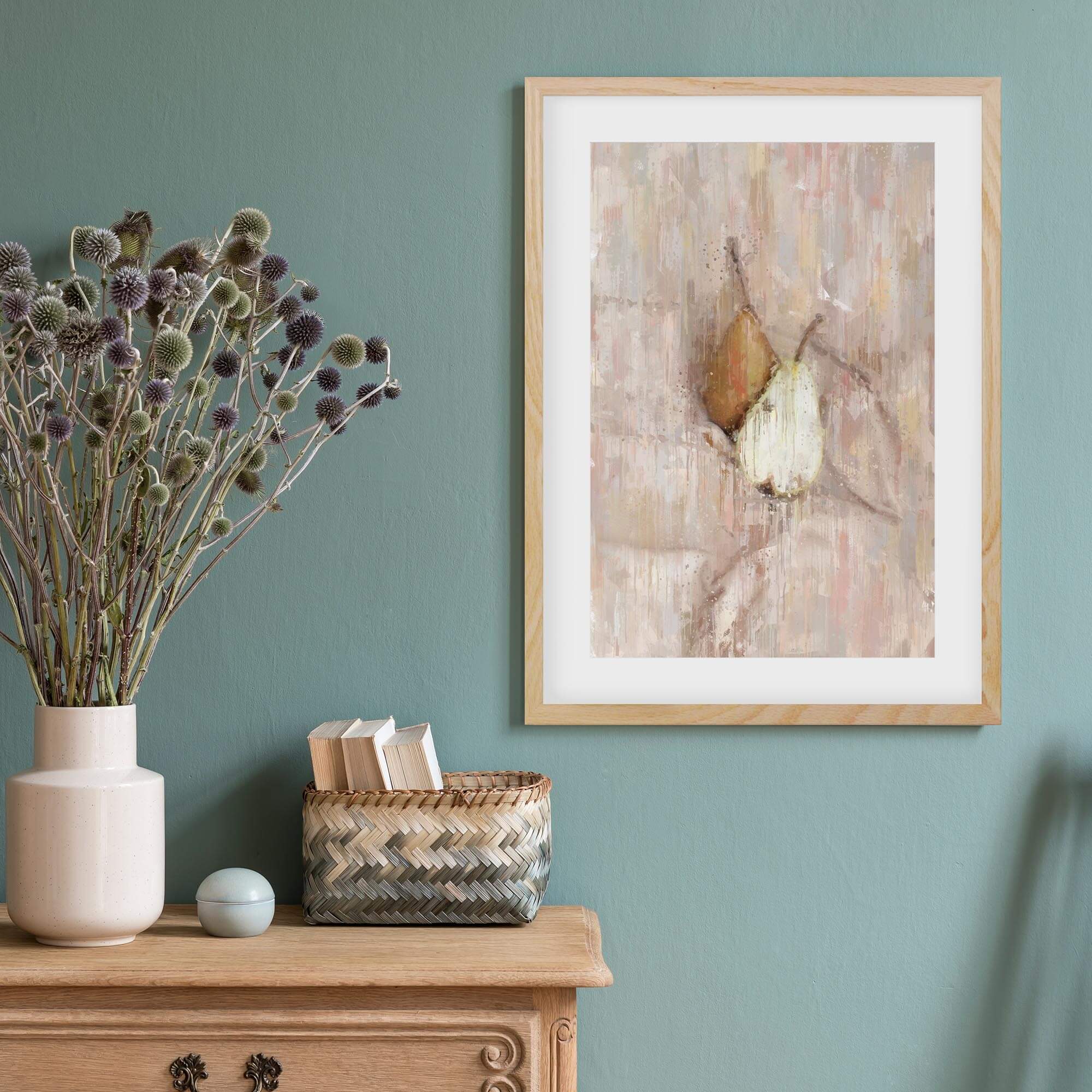 A Pair Of Pears framed print on a teal wall