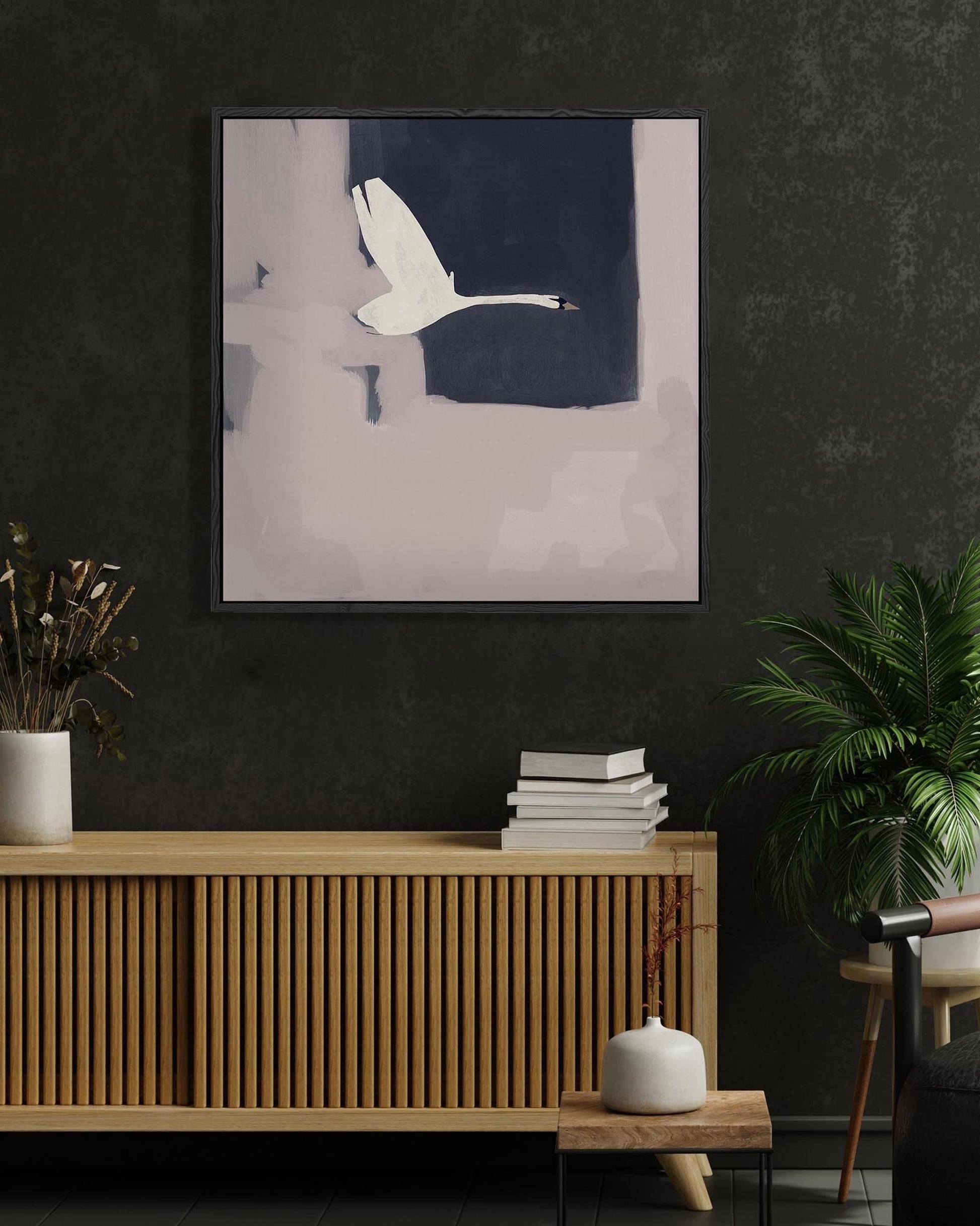 Modern living room with a wooden console table, abstract painting, and plants.