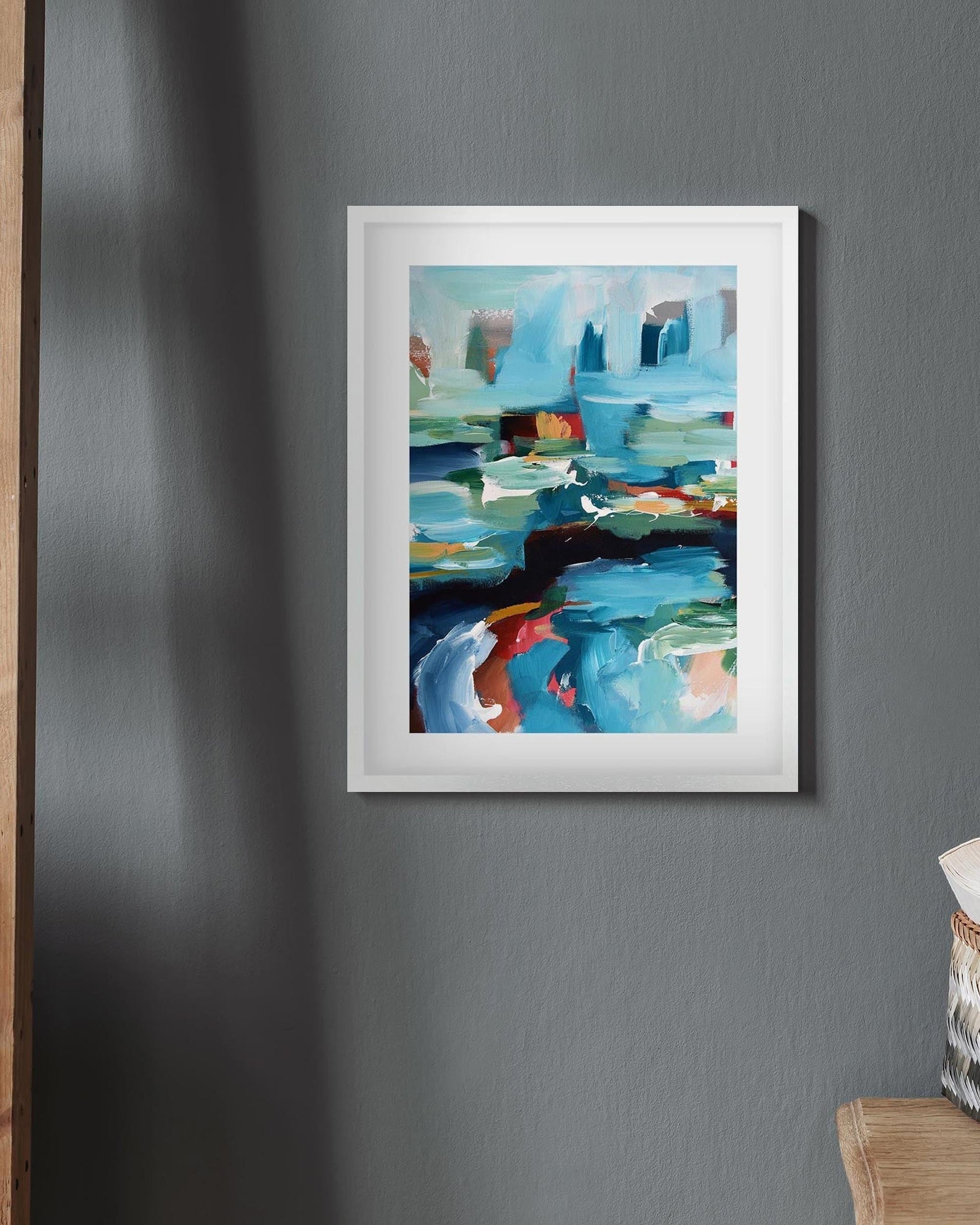 Framed abstract painting on a gray wall