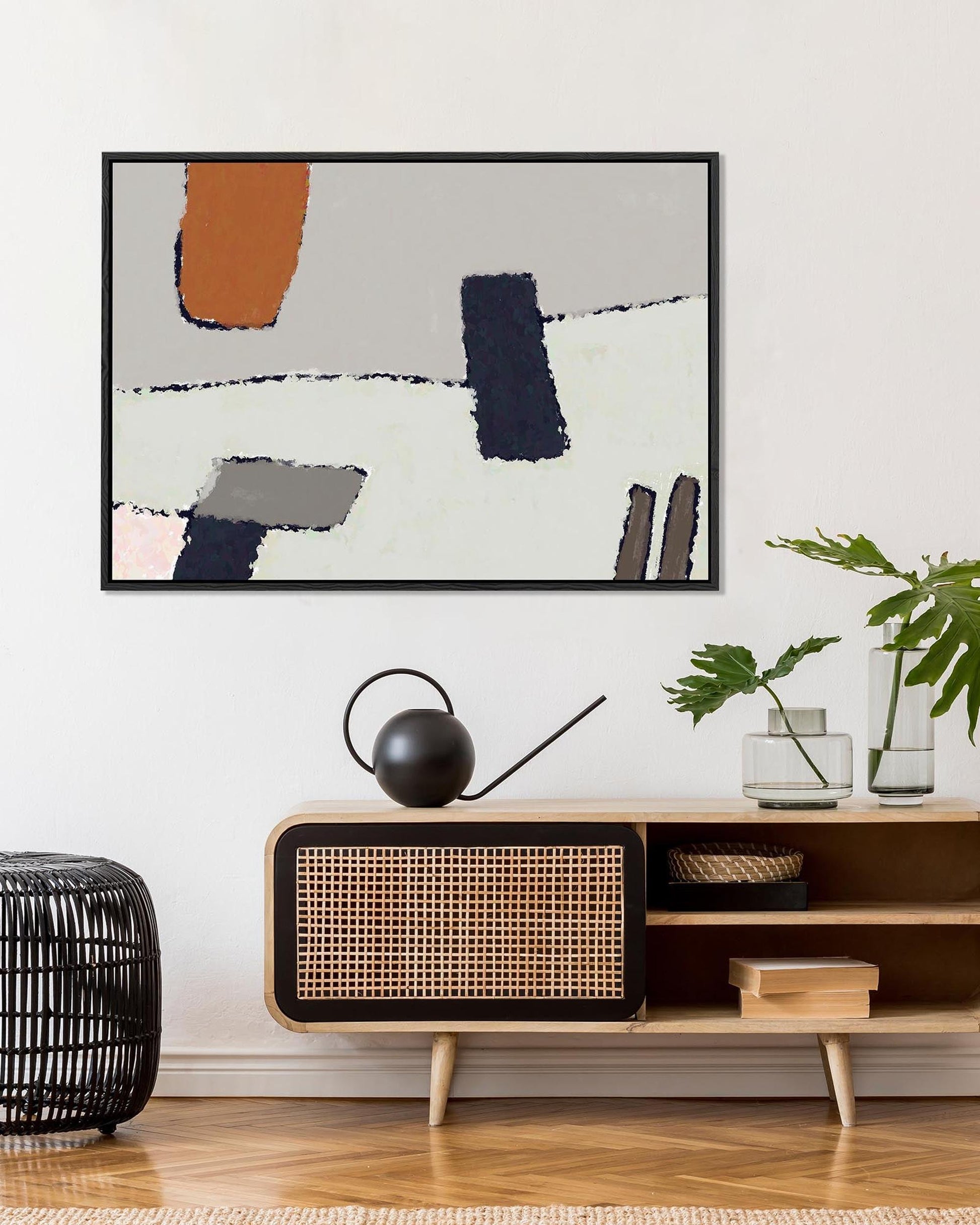 Modern living room with a wooden console table, abstract art, and decorative items.
