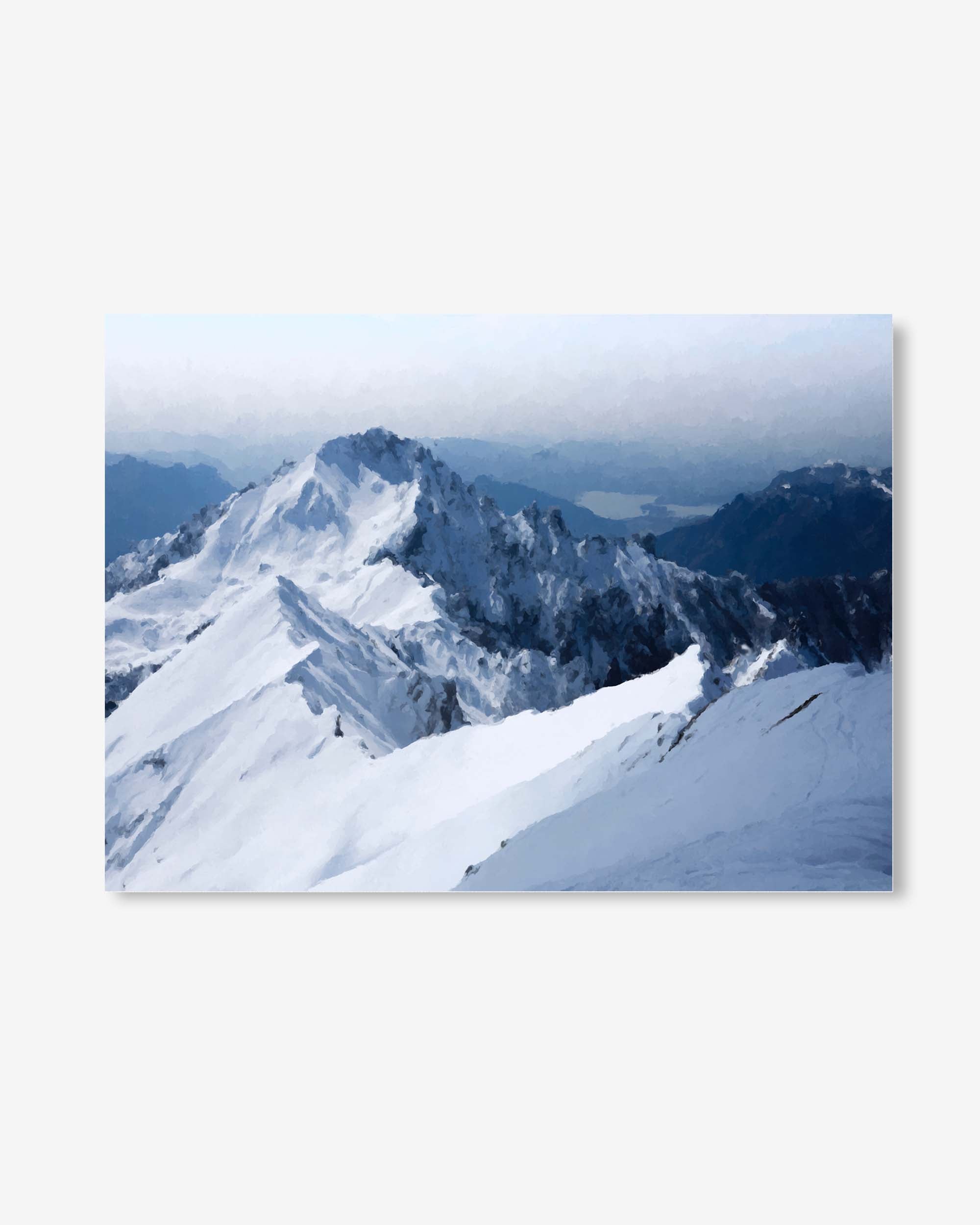 Snowy mountain landscape with a lake in the distance