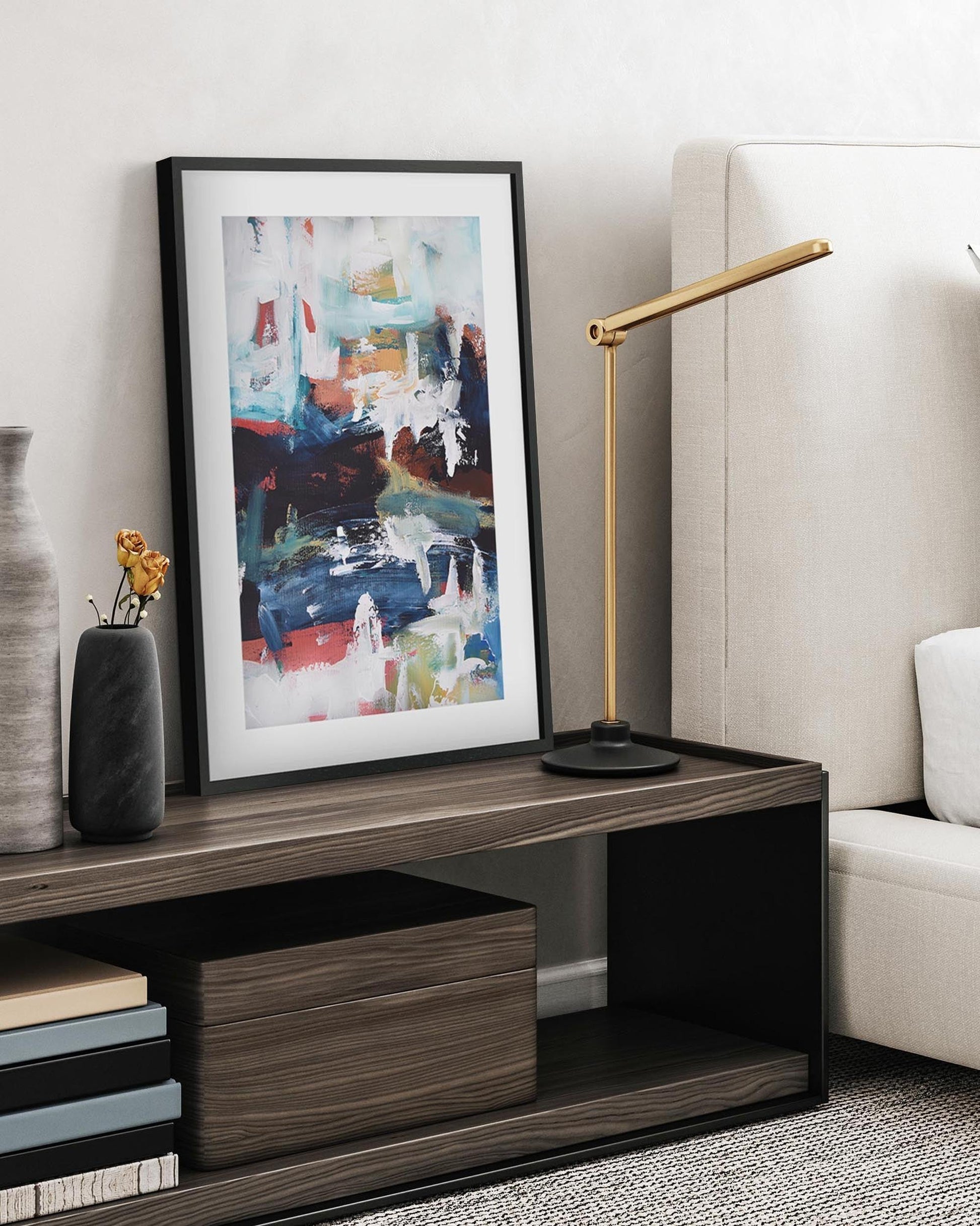 Modern living room with a coffee table, lamp, and artwork