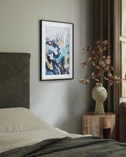 Modern bedroom with abstract art, vase with branches, and wooden nightstand.