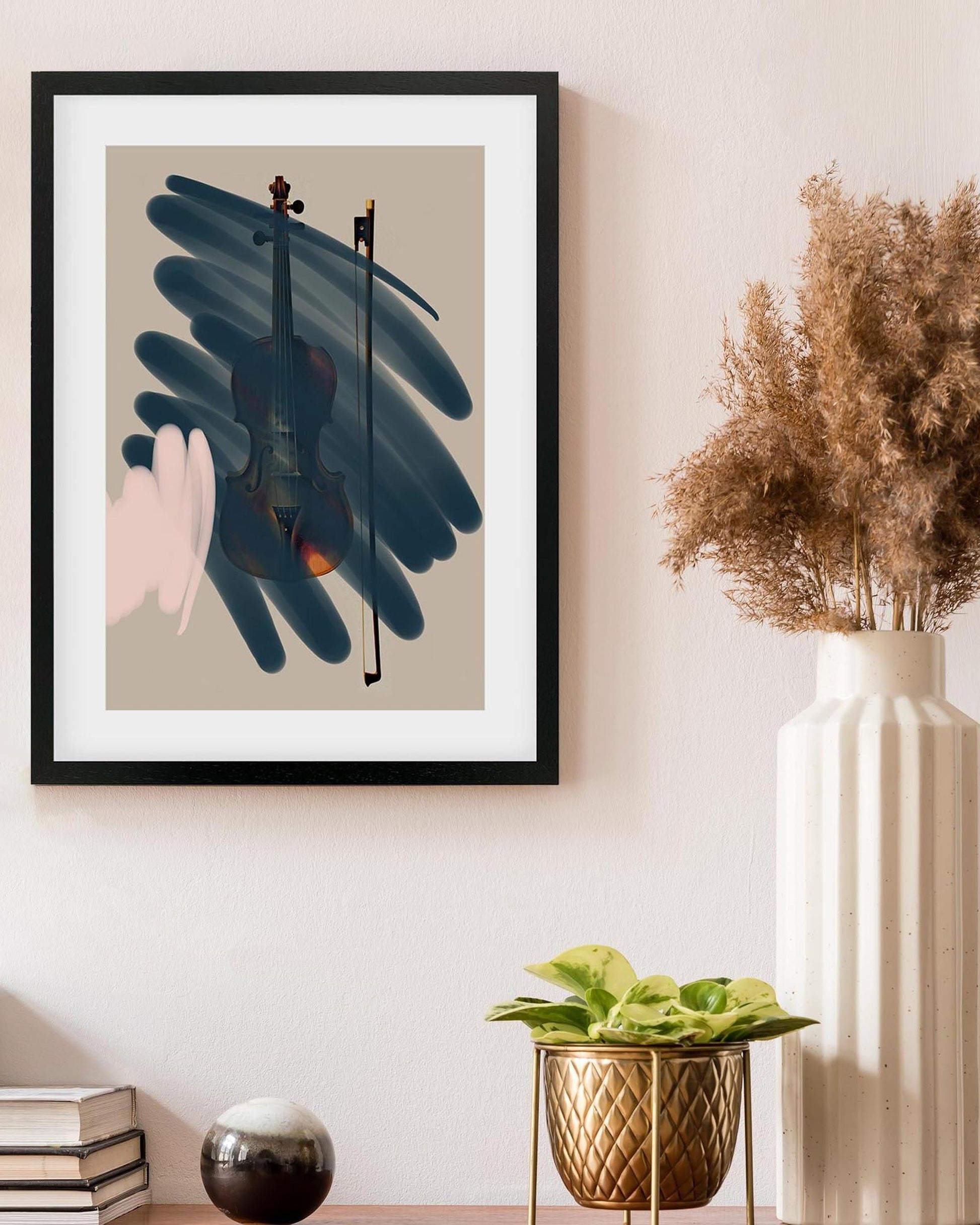 Framed abstract art piece on a wall with decor elements below.