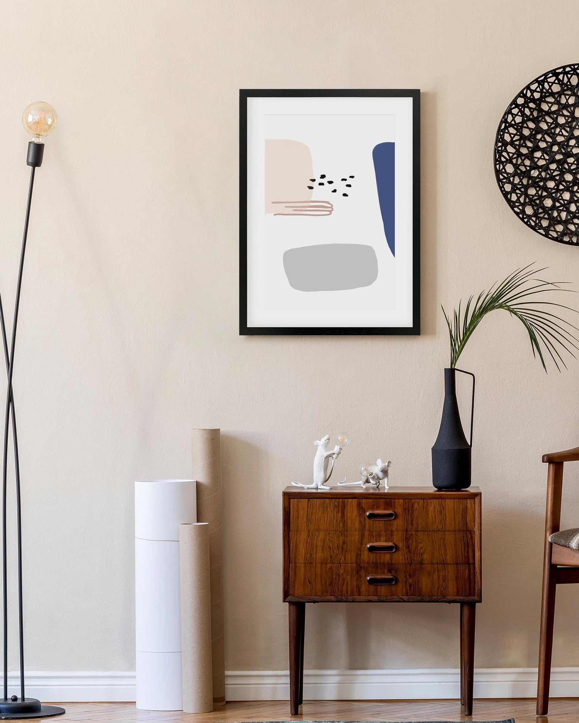 Modern interior with a wooden side table, abstract art, and decorative items.