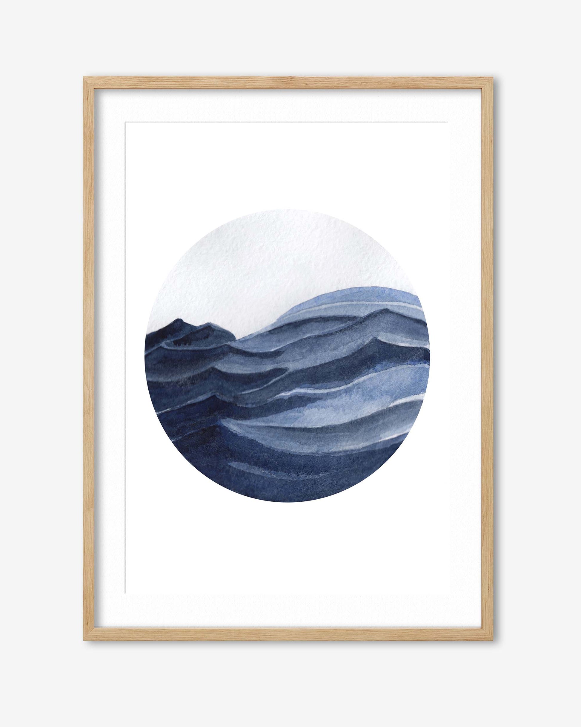 Framed artwork of a stylized mountain landscape with a circular design on a white background