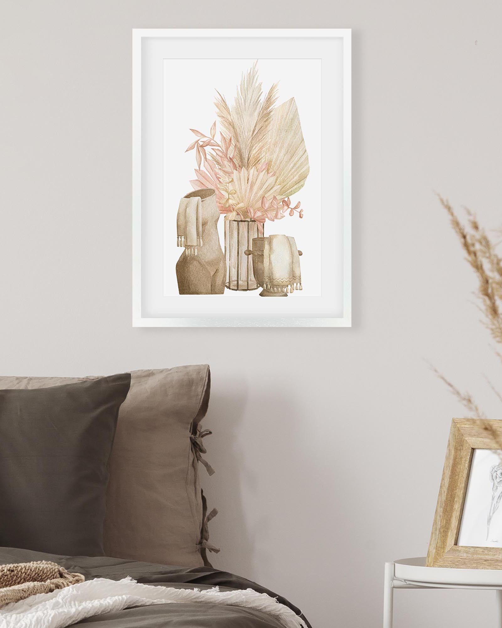 Decorative wall art of a vase with dried flowers in a minimalistic room.