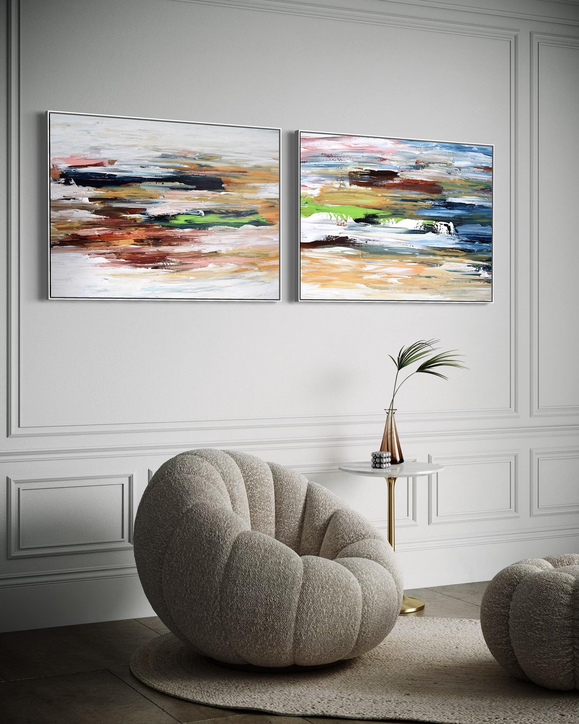 Two abstract paintings on a wall above a modern chair in a stylish room.
