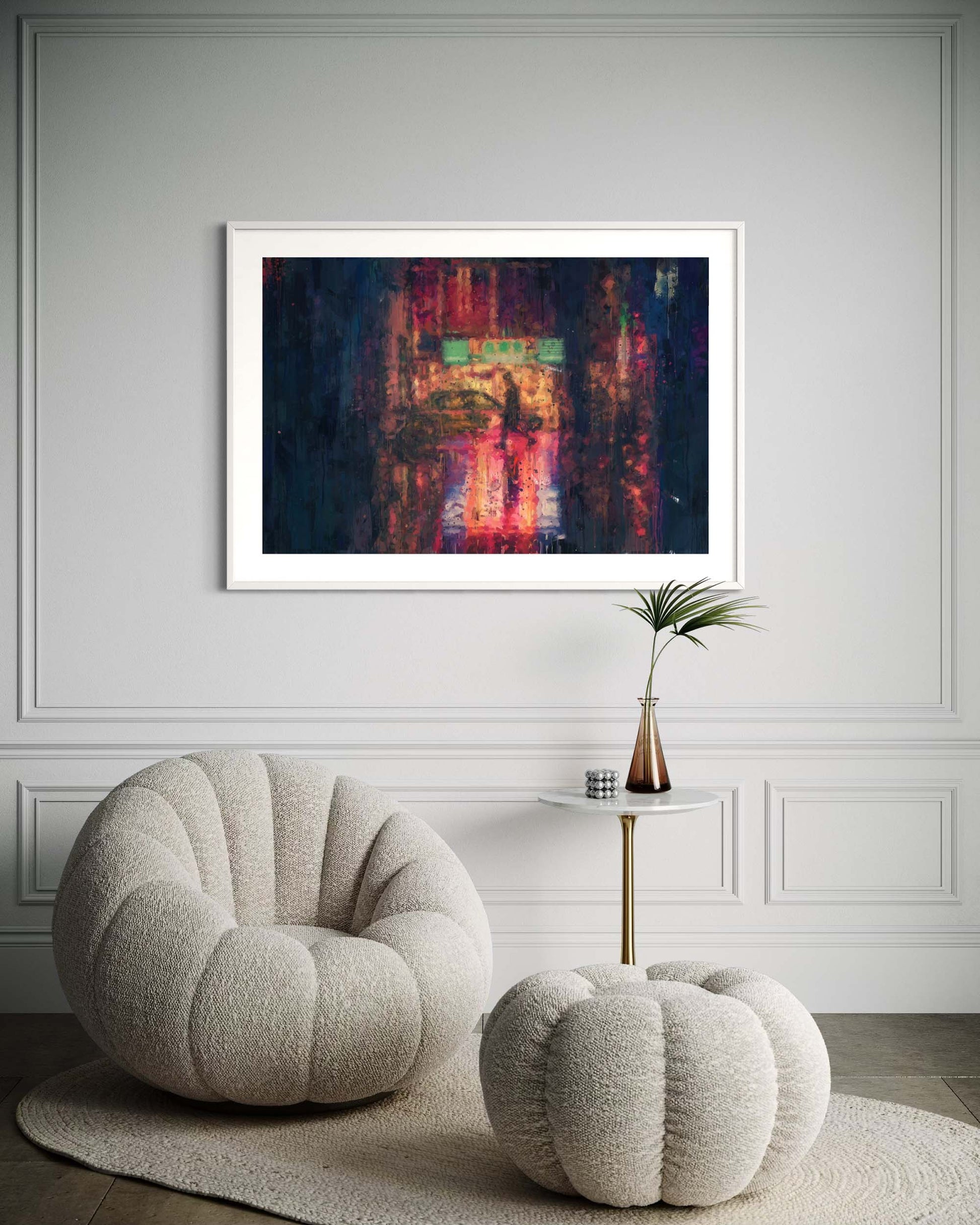 Modern interior with a textured armchair, ottoman, and abstract painting on a wall.