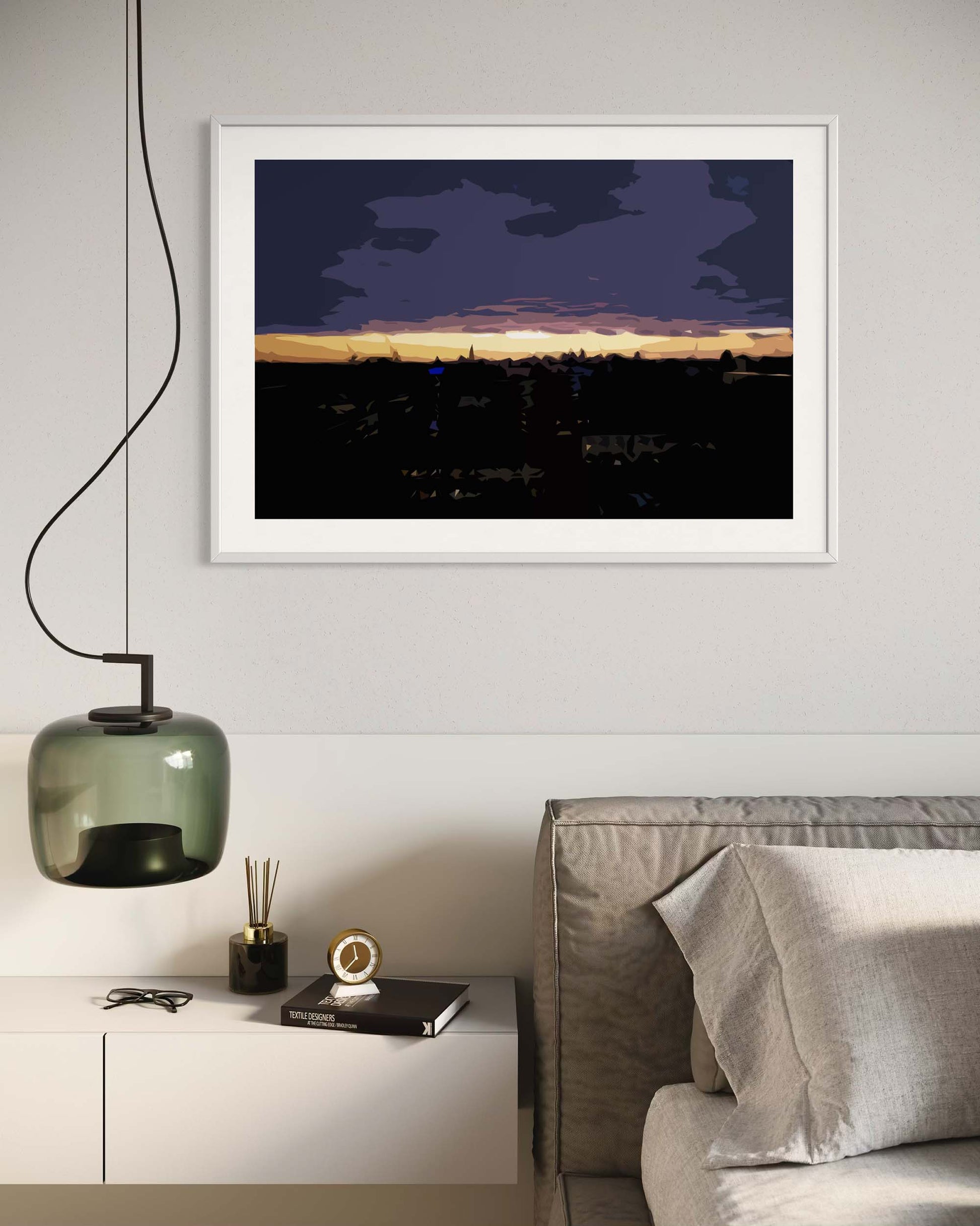 Framed artwork of a city skyline at dusk in a modern living room.
