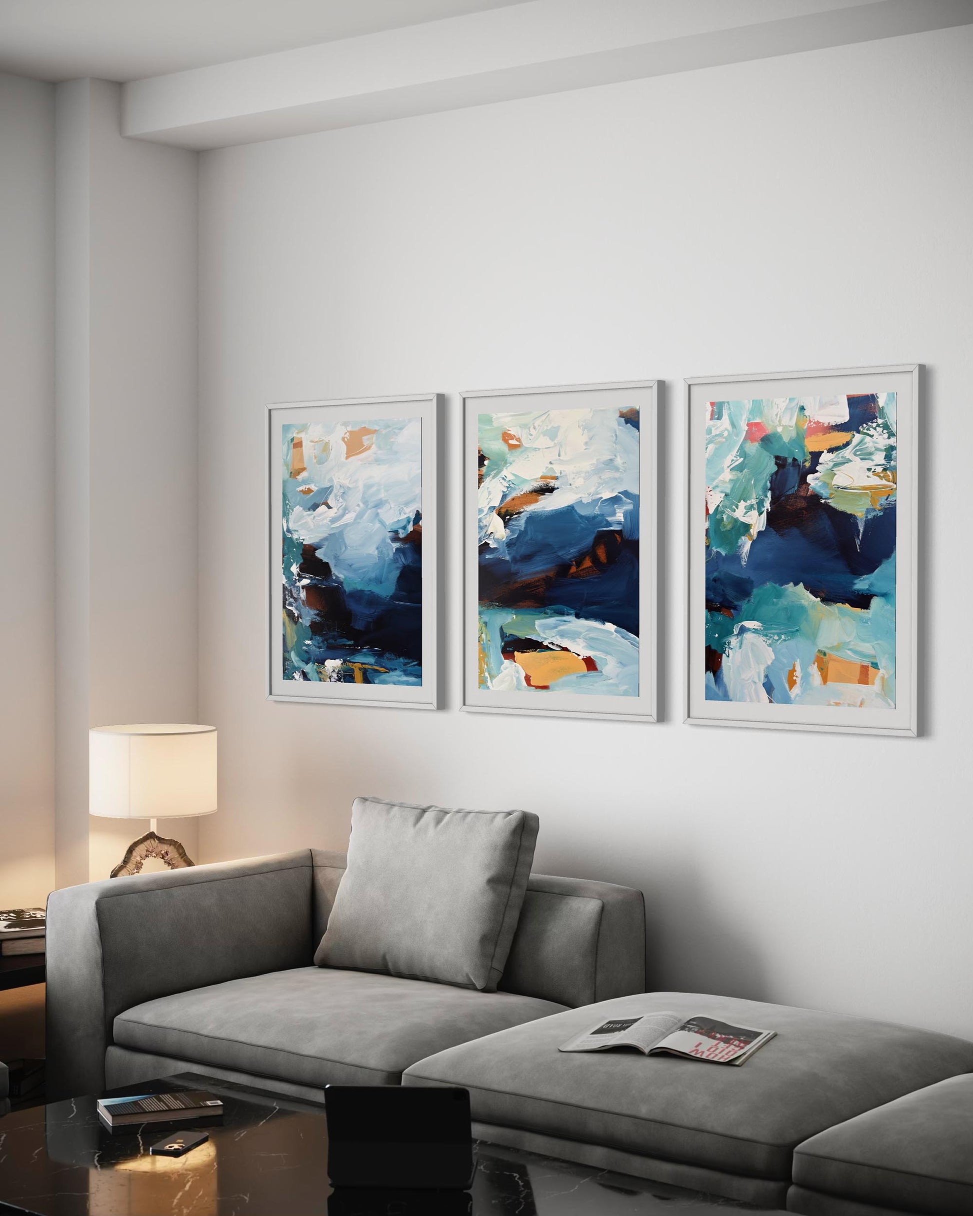 Living room with a gray sofa and three abstract art pieces on the wall.