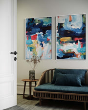 Living room with abstract paintings on the wall and a wooden sofa.