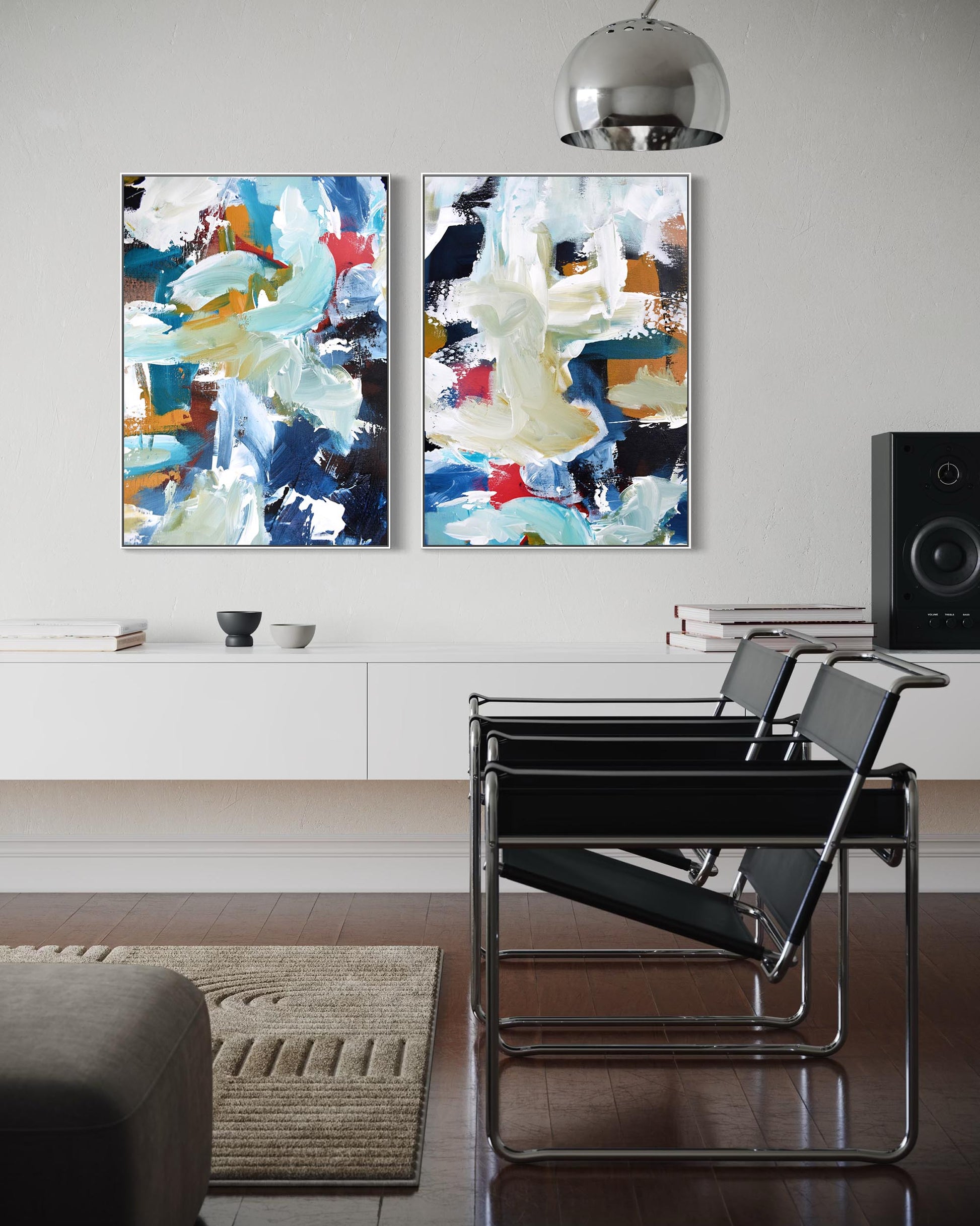 Modern living room with abstract art on the wall and a black chair.