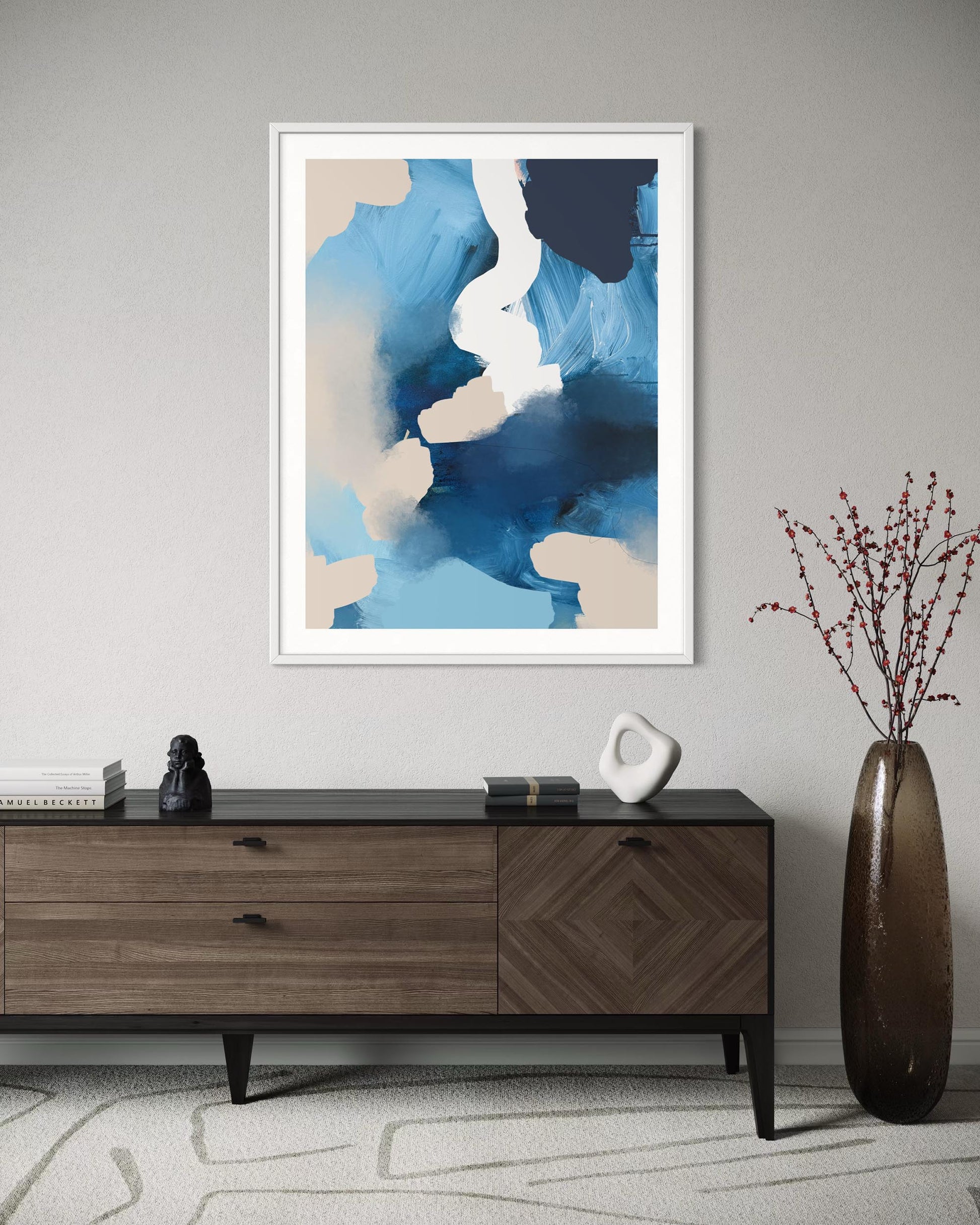 Abstract art print on a wall above a wooden console table with decorative items.