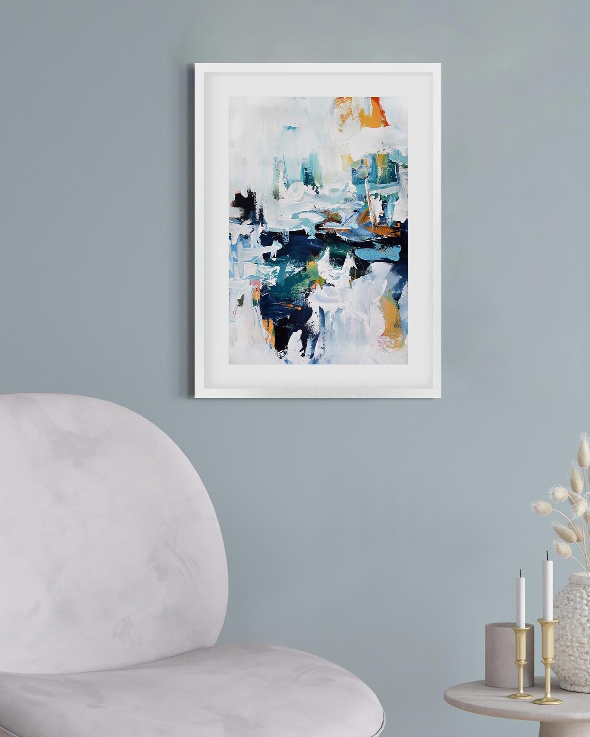 abstract art print framed on a blue wall