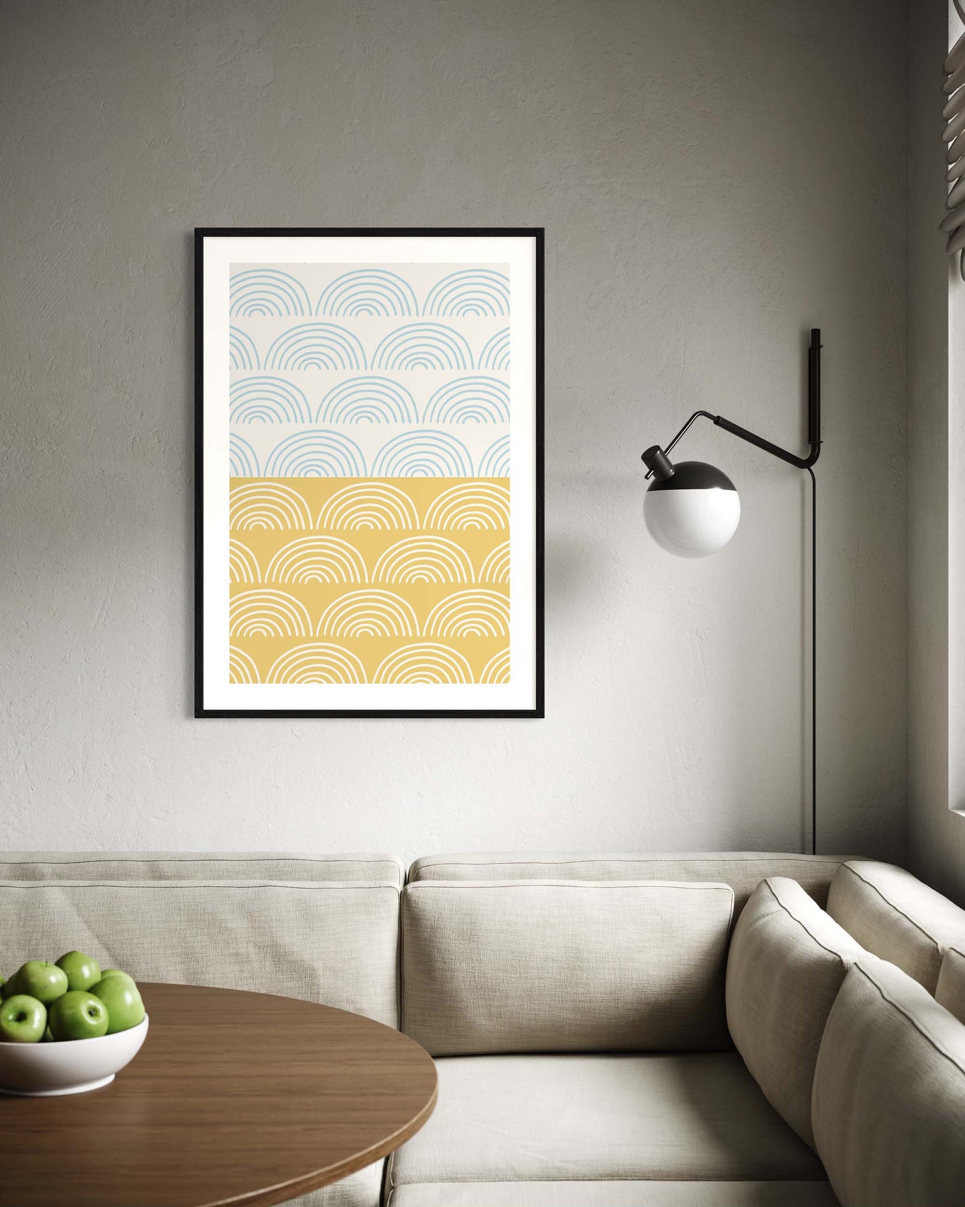 Framed abstract art print on a wall above a sofa in a living room.