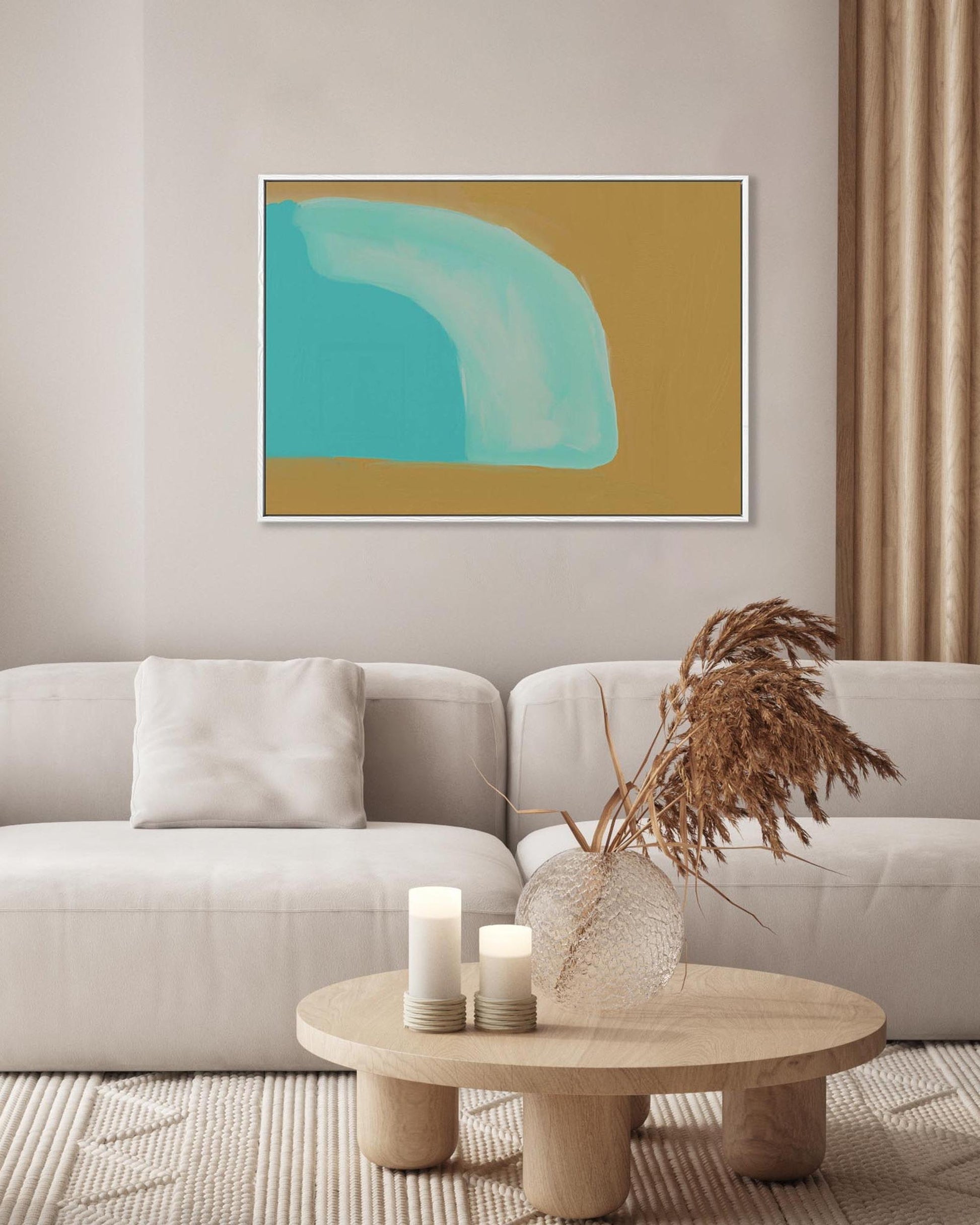 Living room with a beige sofa, abstract art on the wall, and a coffee table with decor items.