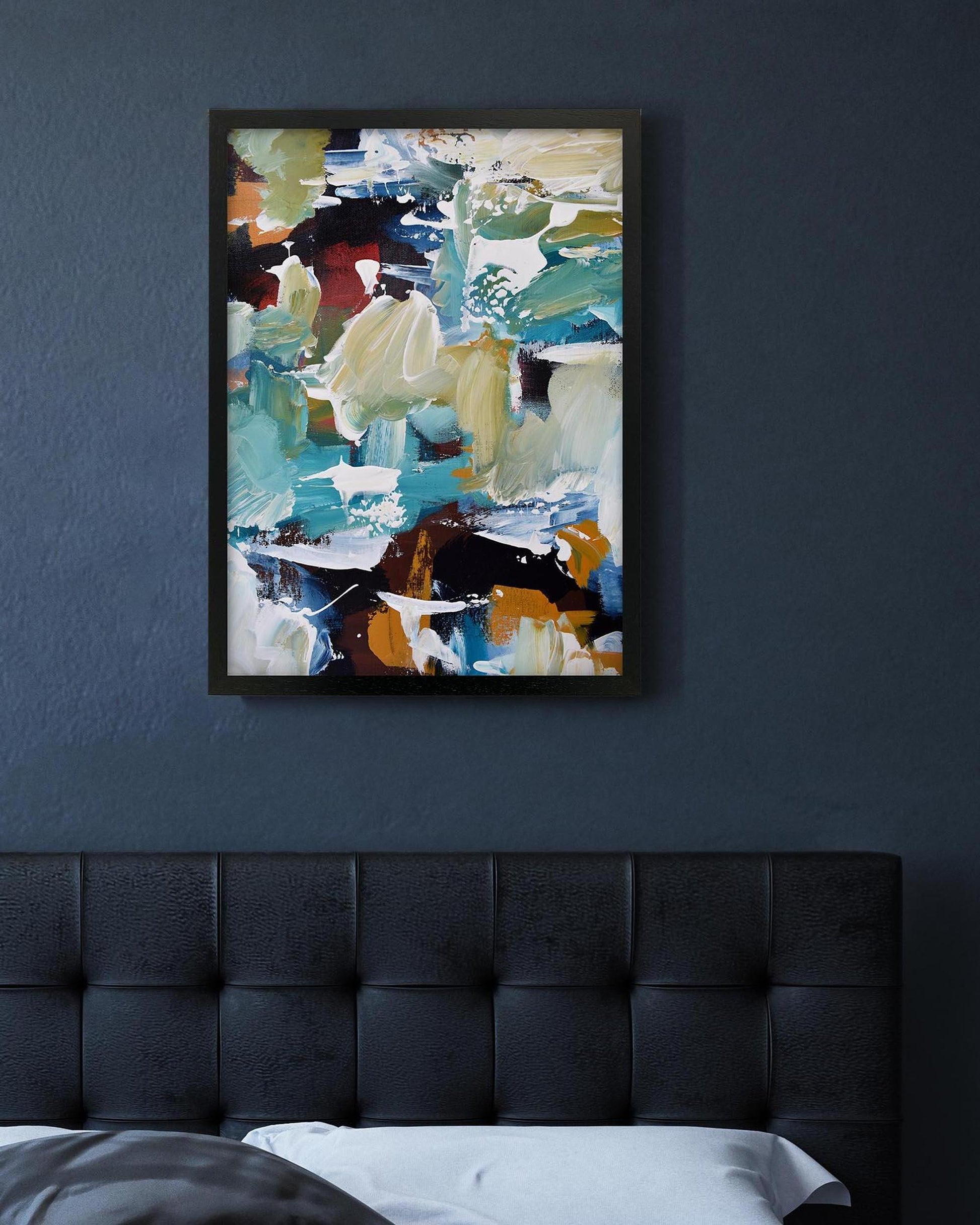 Abstract painting on a dark wall above a bed with a tufted headboard.