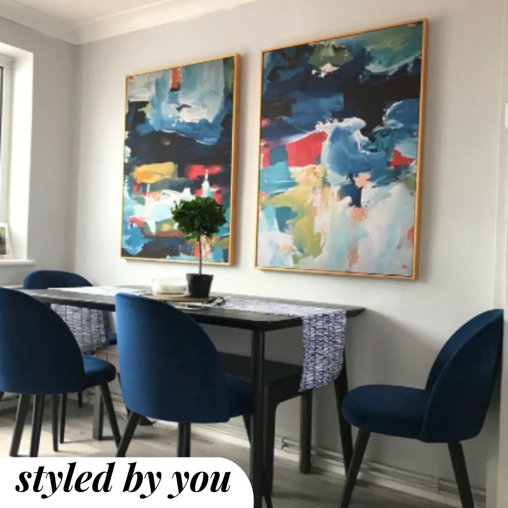 framed canvas prints above a dining table