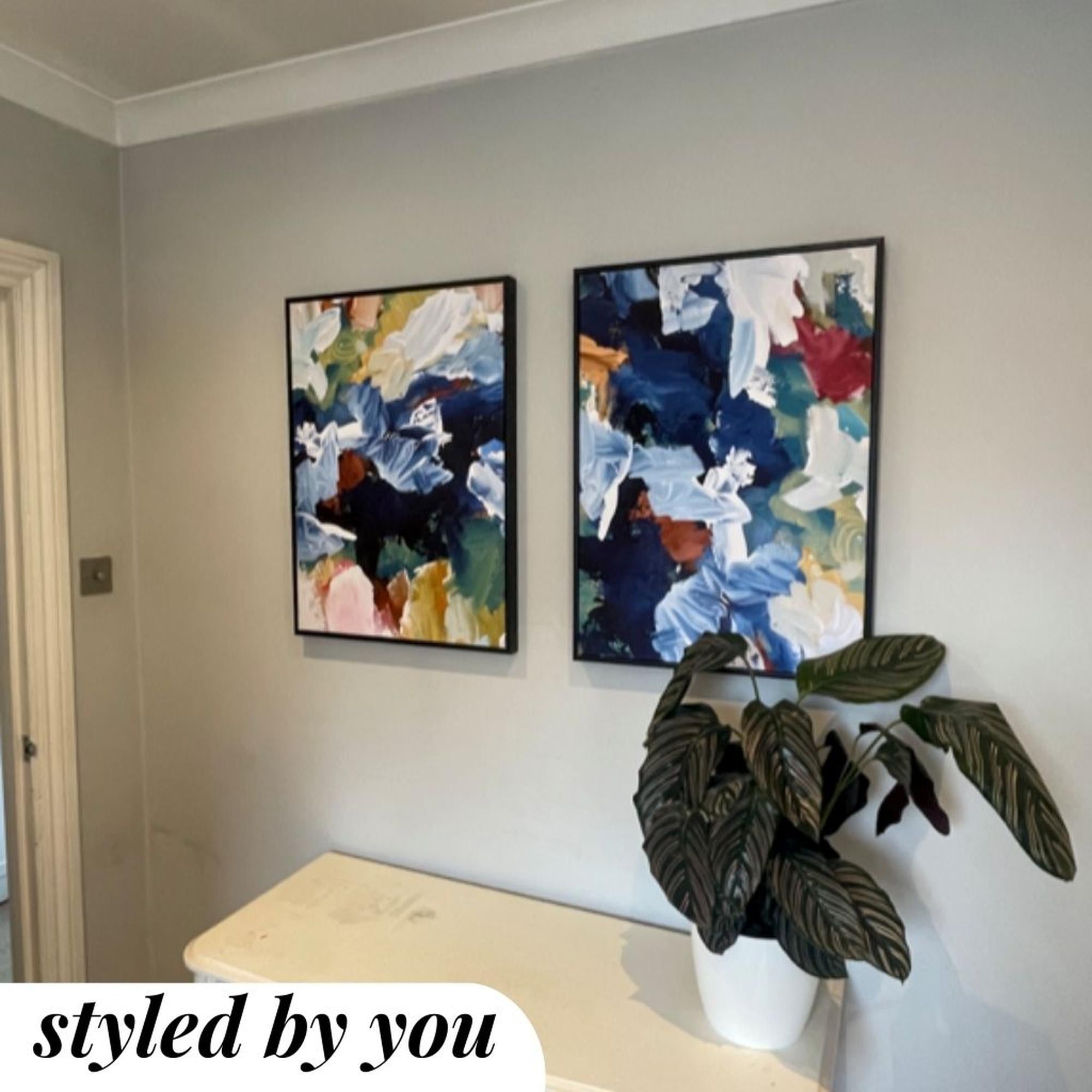 framed canvas prints above a plant