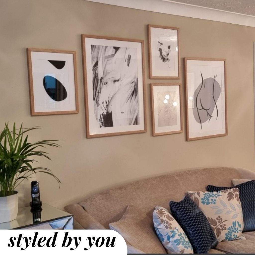 framed gallery wall prints hung on wall